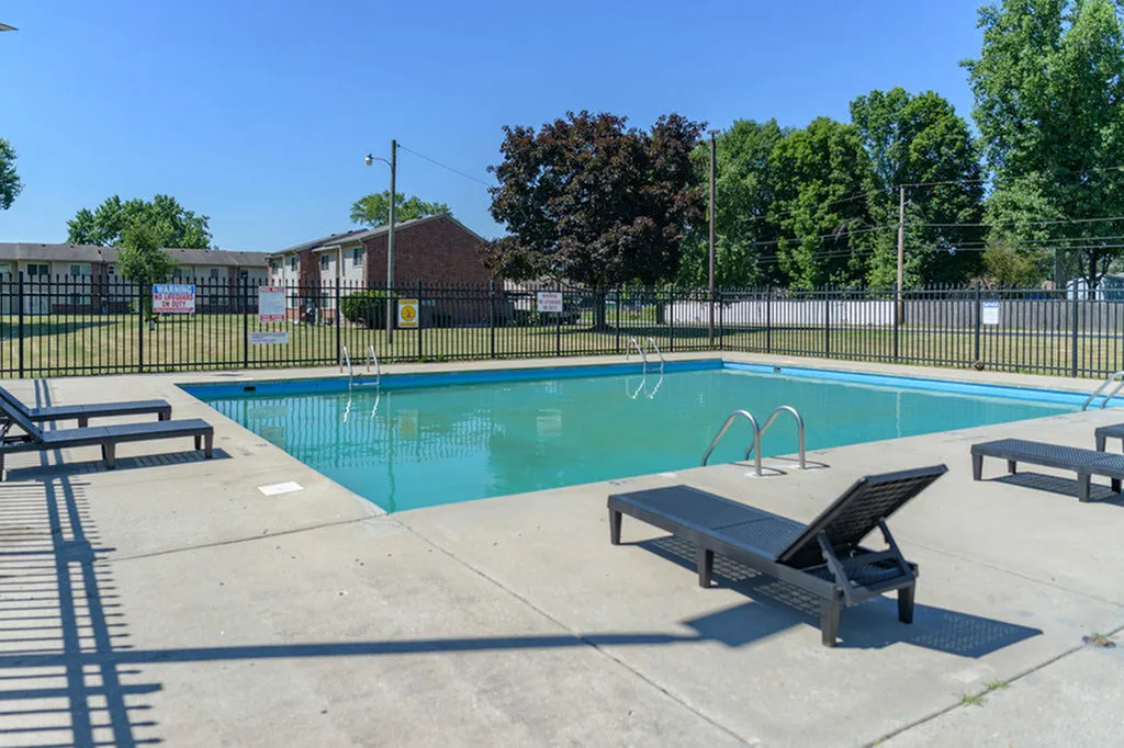 Inviting outdoor pool area with comfortable lounge chairs, ideal for relaxation and leisure in a serene setting.