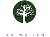 Logo of The Orchard on Wallen featuring a vibrant white tree with red apples on a dark green background, evoking a sense of community and natural beauty.