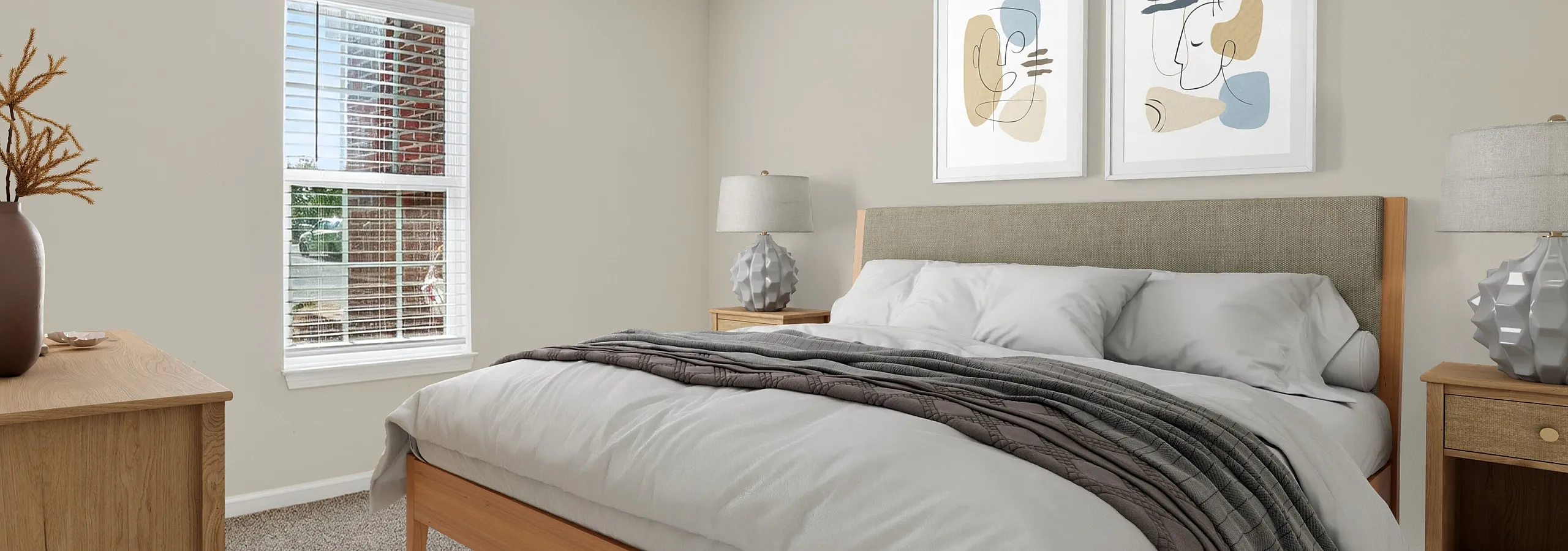 Inviting bedroom with plush bed, stylish artwork, and natural light through a large window for a serene atmosphere.