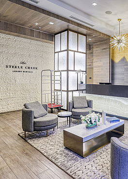 Elegant lobby of Steele Creek Luxury Rentals featuring modern decor, comfortable seating, and stylish lighting.