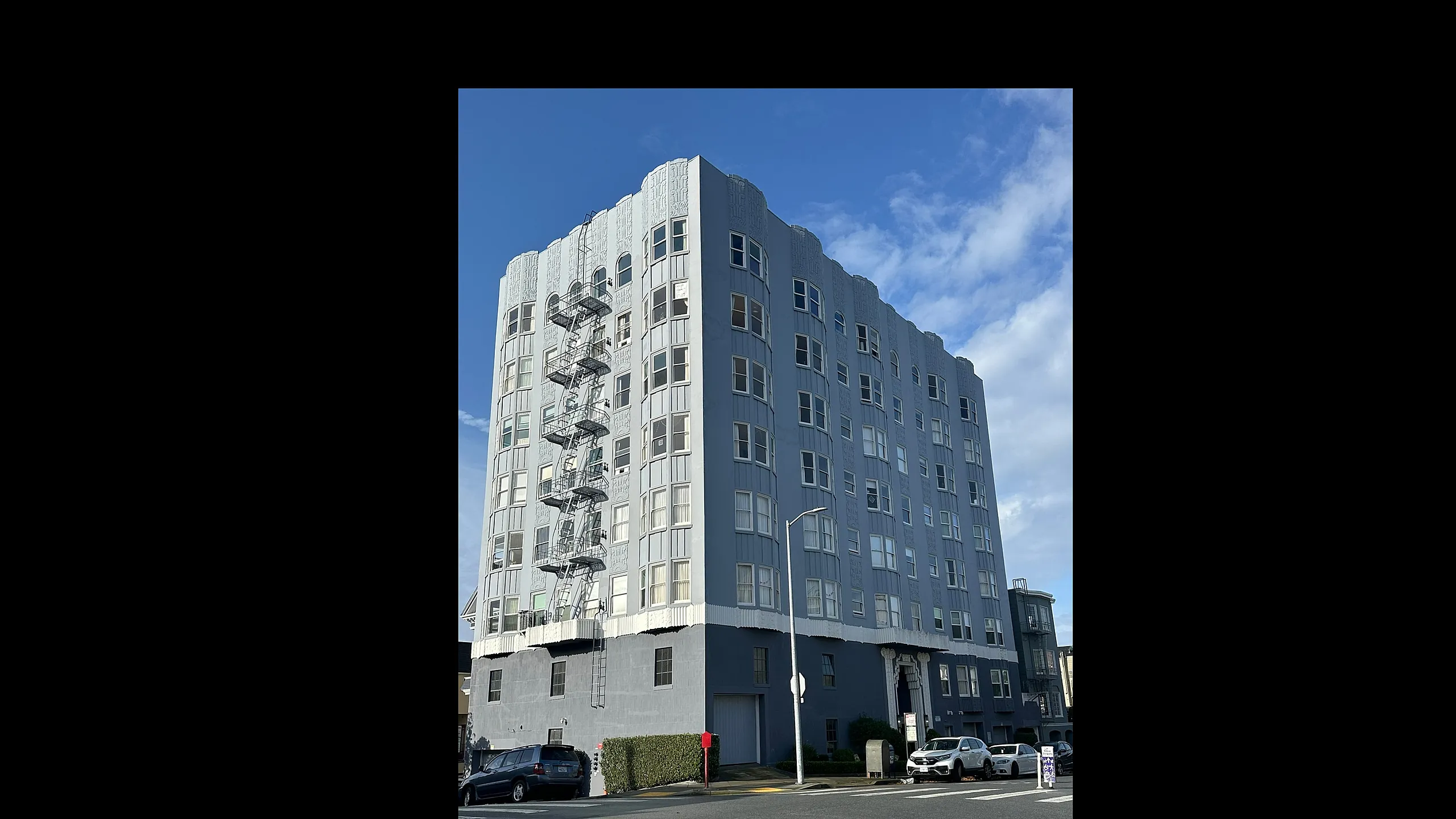 Elegant eight-story apartment building with classic architectural details, large windows, and a convenient city location.