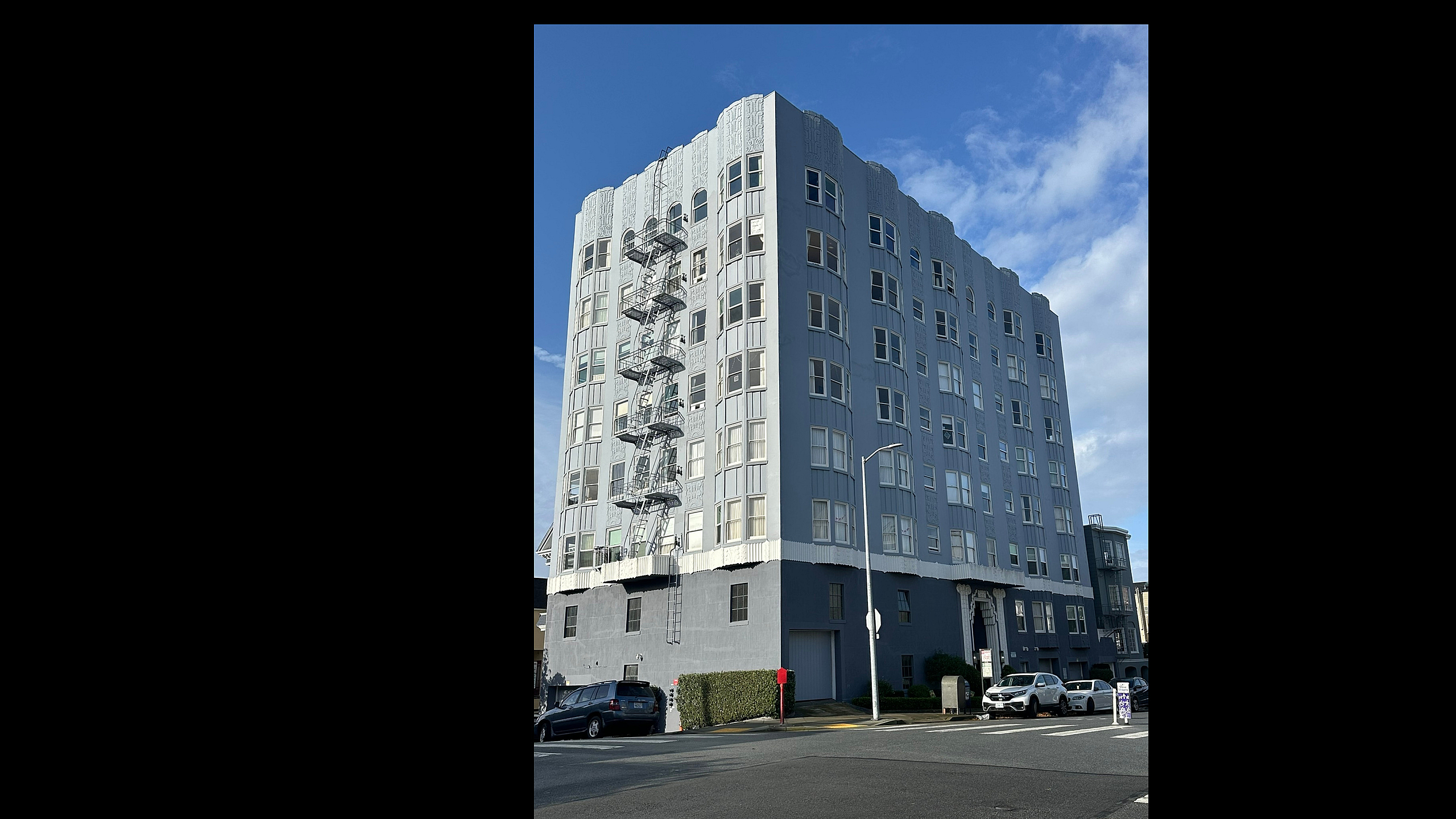 Charming art deco-style apartment building with intricate exterior detailing, offering modern urban living in a vibrant neighborhood.