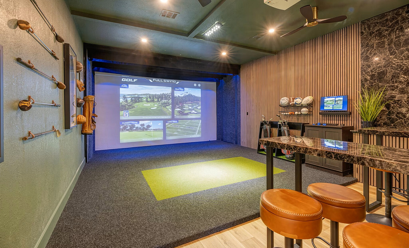 Luxurious indoor golf simulator room featuring cutting-edge technology, elegant seating, and sophisticated decor.