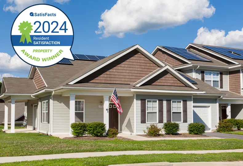 Charming modern home with solar panels, showcasing a 2024 resident satisfaction award.