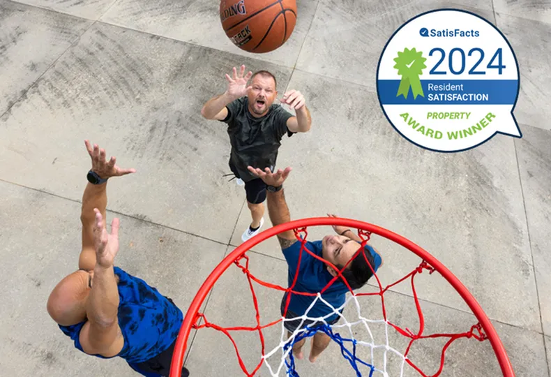 Energetic basketball game on a court, featuring residents enjoying outdoor activities.