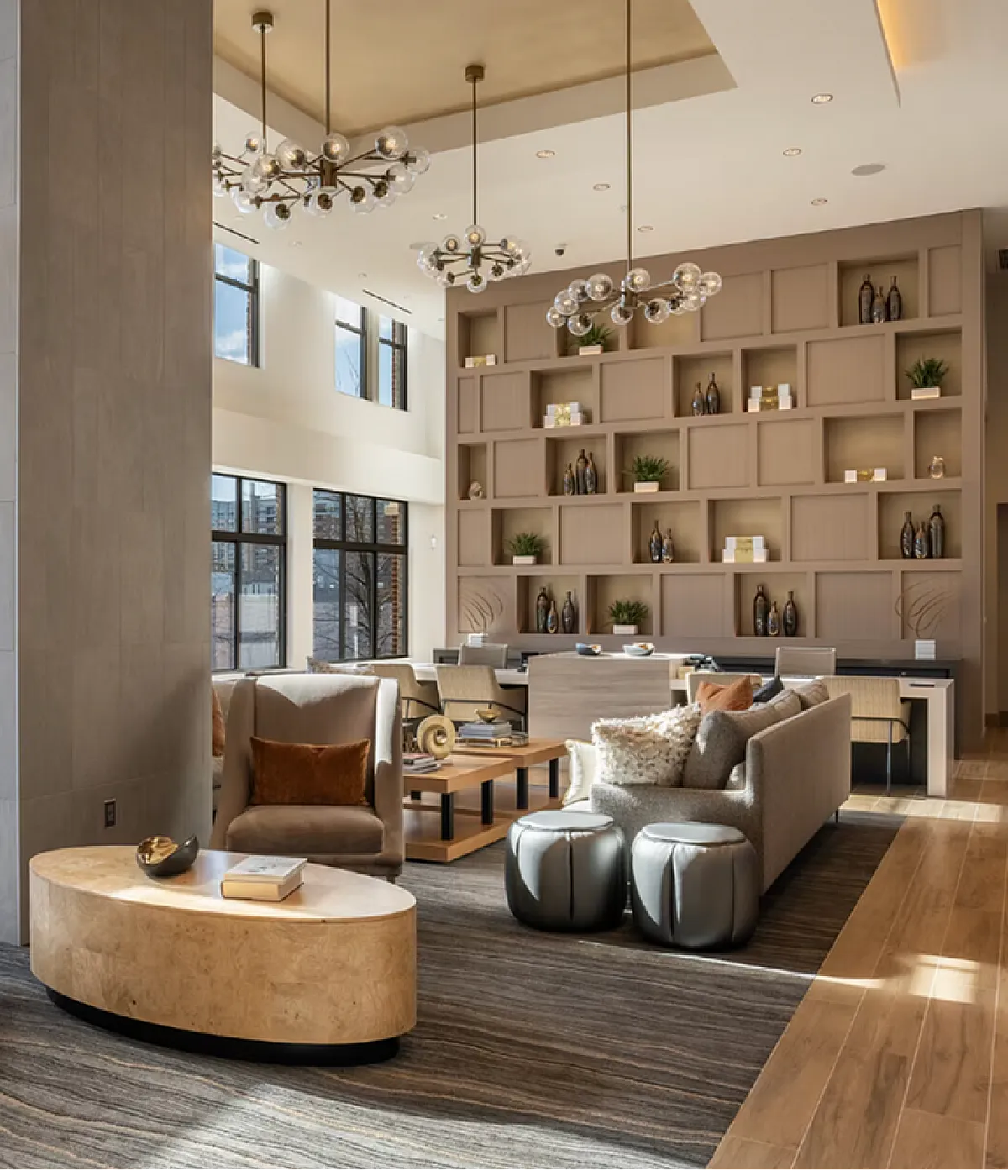 Luxurious modern living area with elegant seating, floor-to-ceiling windows, and chic decor, perfect for relaxation and entertaining.