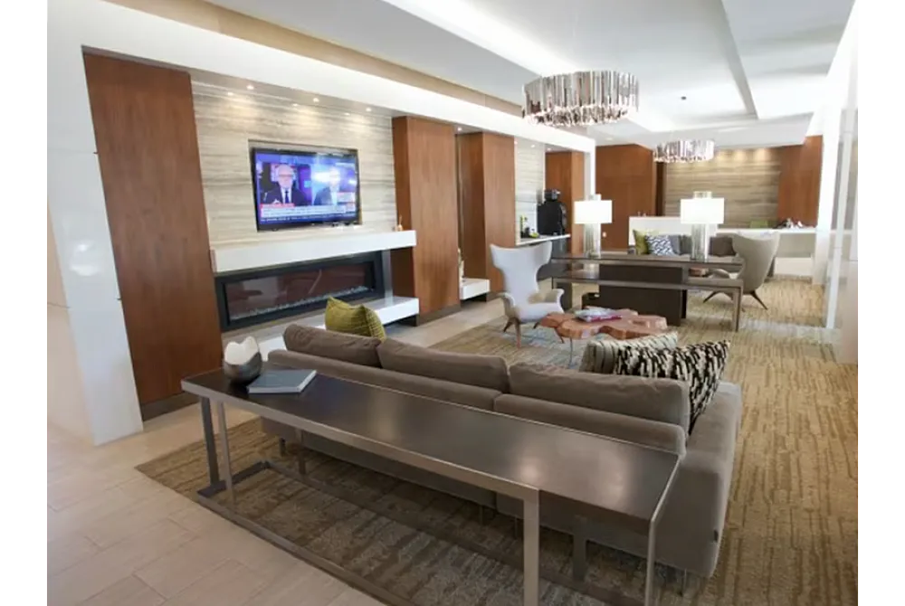 Luxurious open-concept living area with modern decor, cozy seating, an elegant fireplace, and chic lighting fixtures.