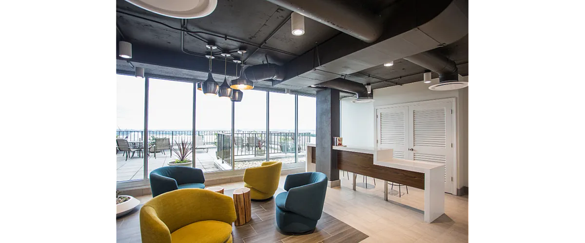 Modern lounge area with stylish seating and chic lighting, offering stunning views through expansive windows.