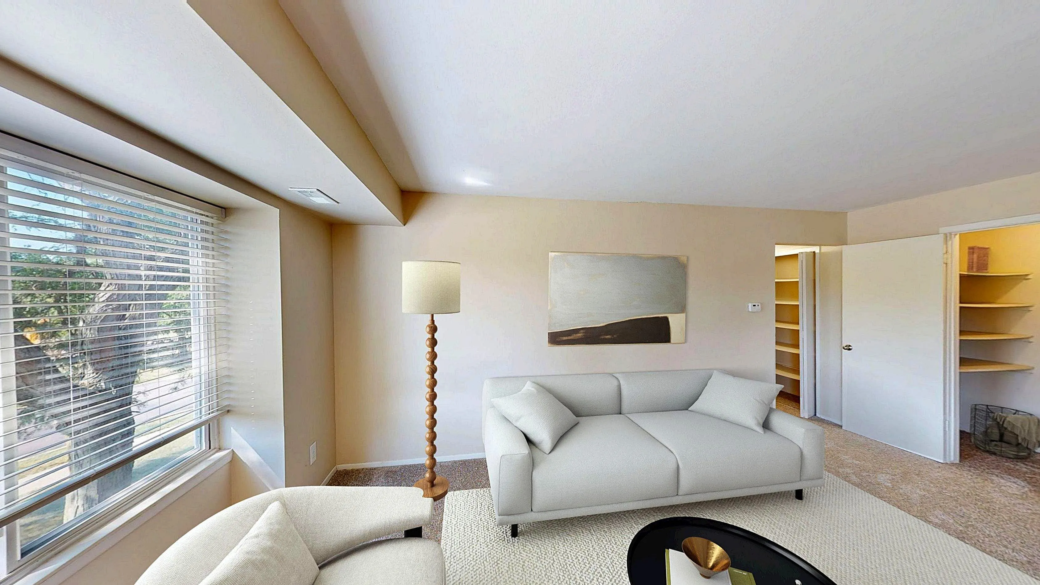 Bright and inviting living room with large window, modern furniture, and stylish decor, perfect for relaxation and comfort.