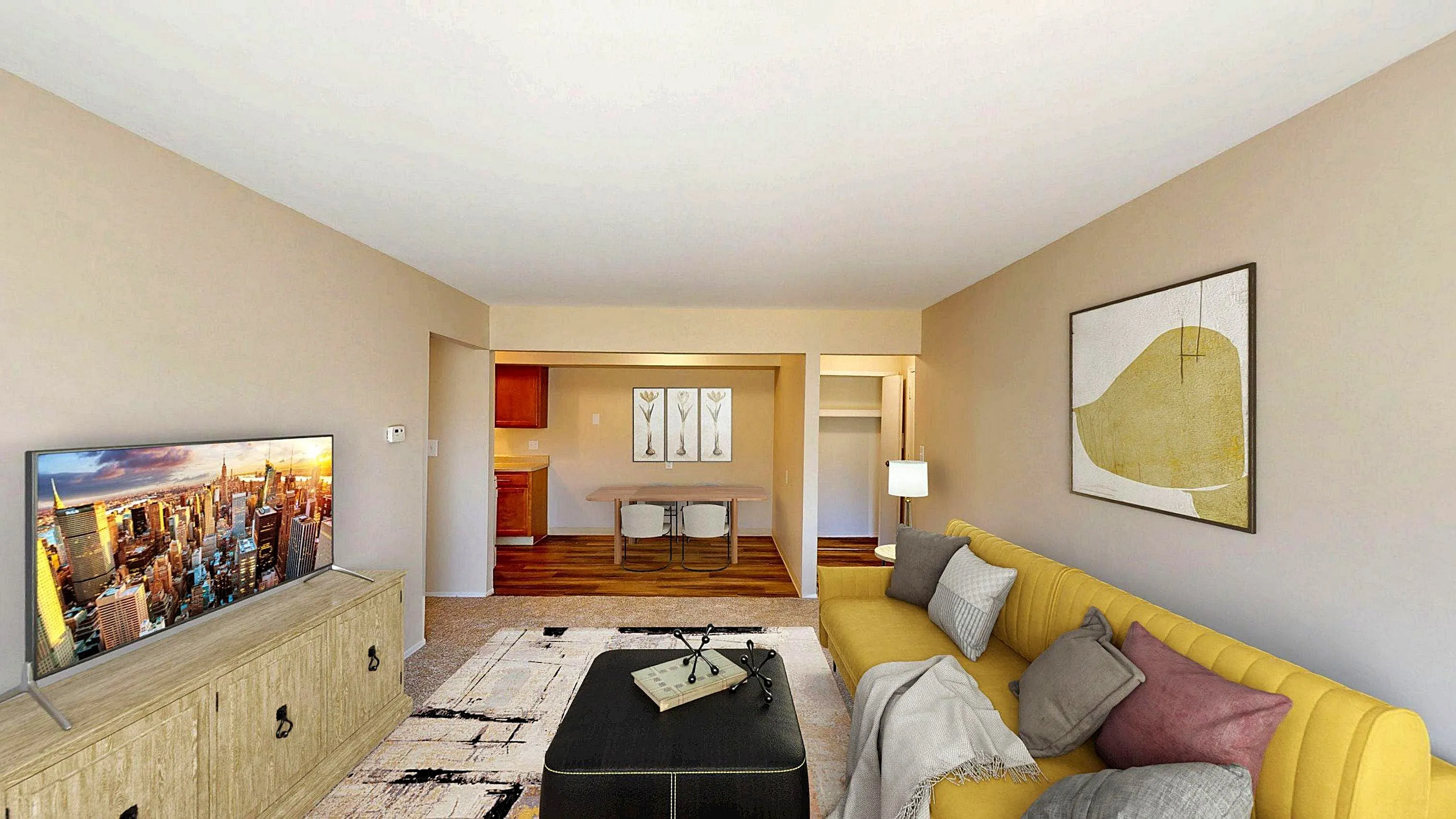 Inviting living room with a stylish yellow sofa, modern wall art, and a sleek TV setup on a wooden console.