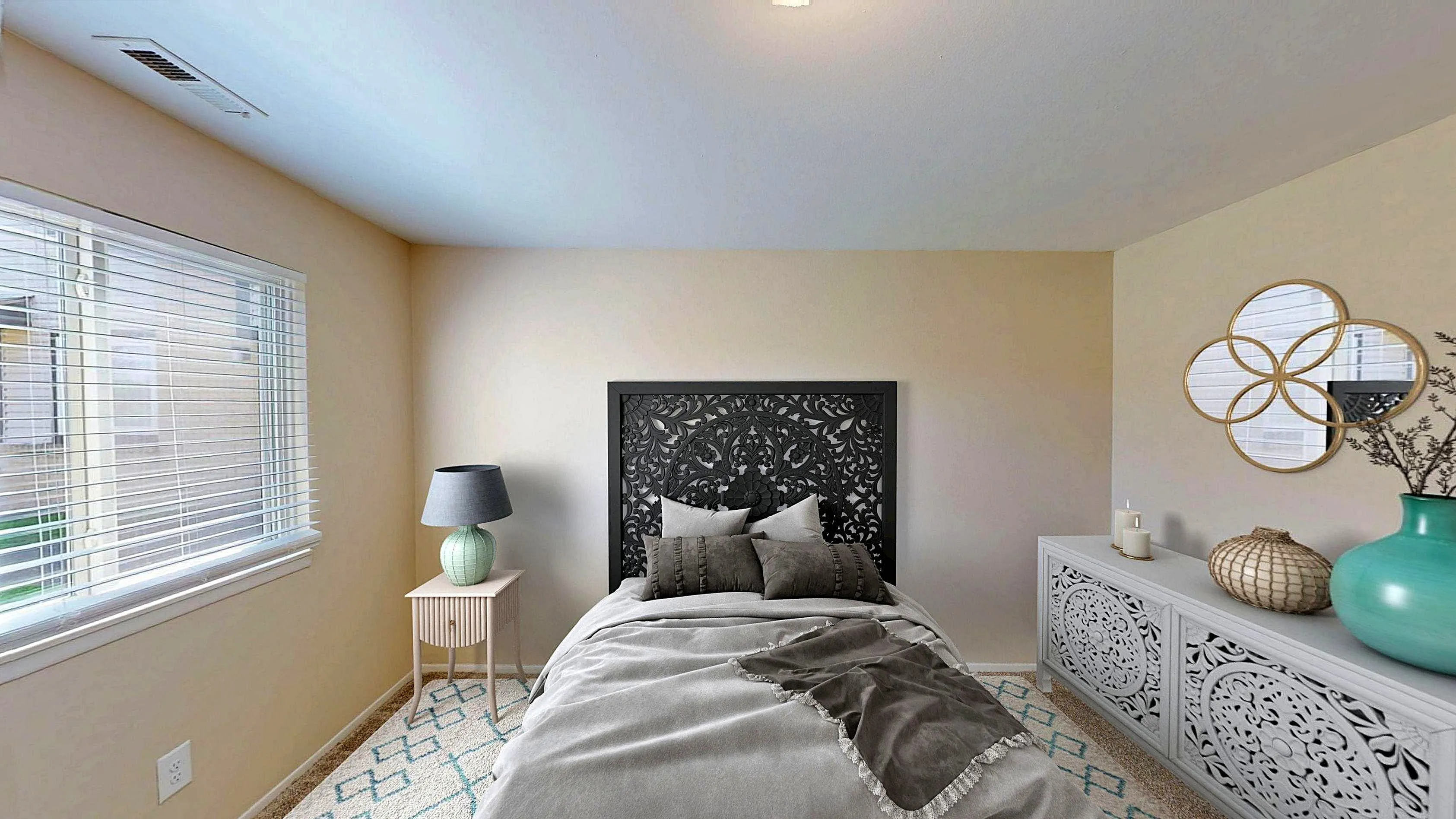 Elegant bedroom with ornate black headboard, stylish bedside lamp, and decorative mirrors, creating a serene atmosphere.