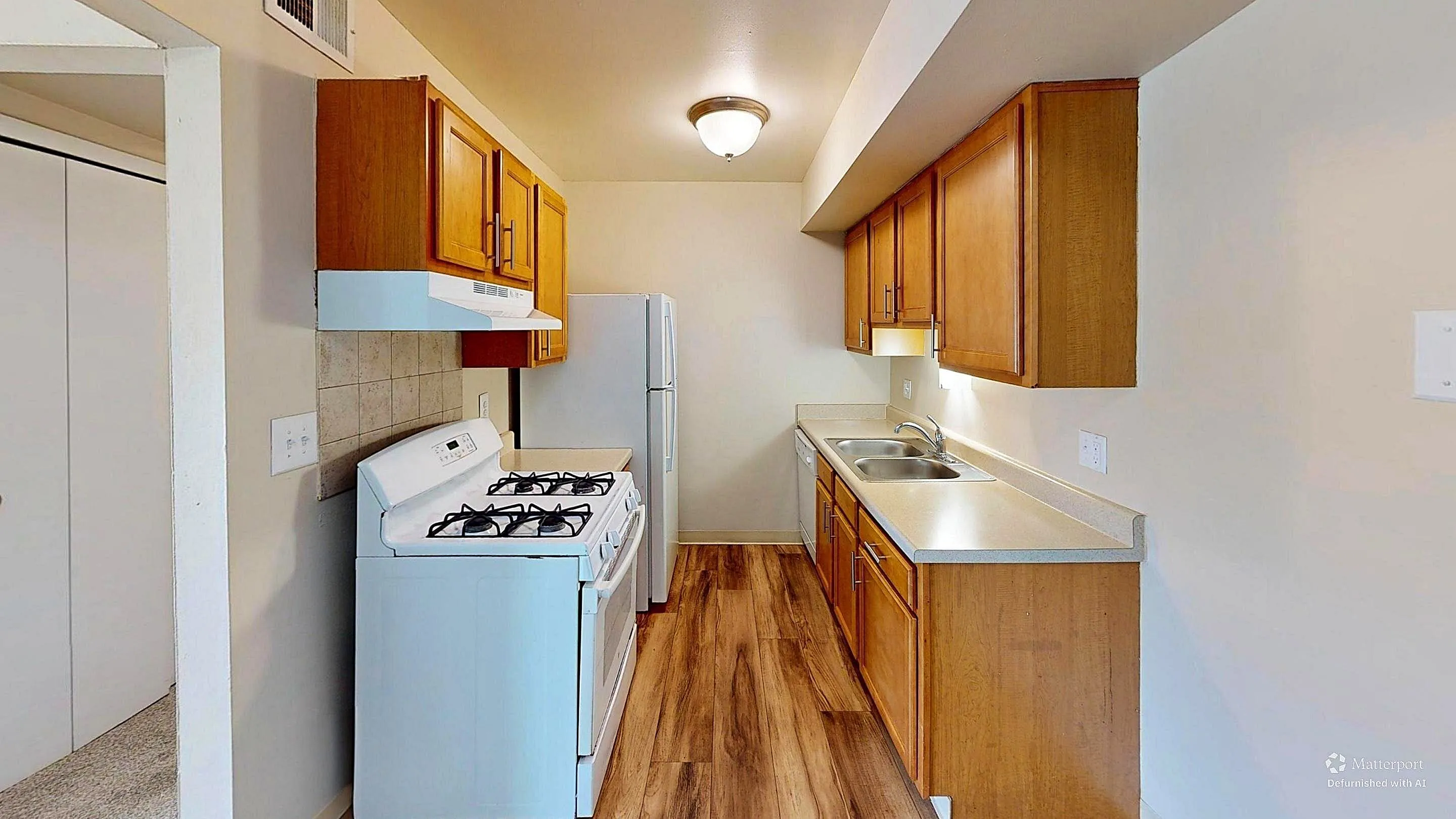 Inviting kitchen with wooden cabinets, modern appliances, and sleek countertops, perfect for culinary enthusiasts.