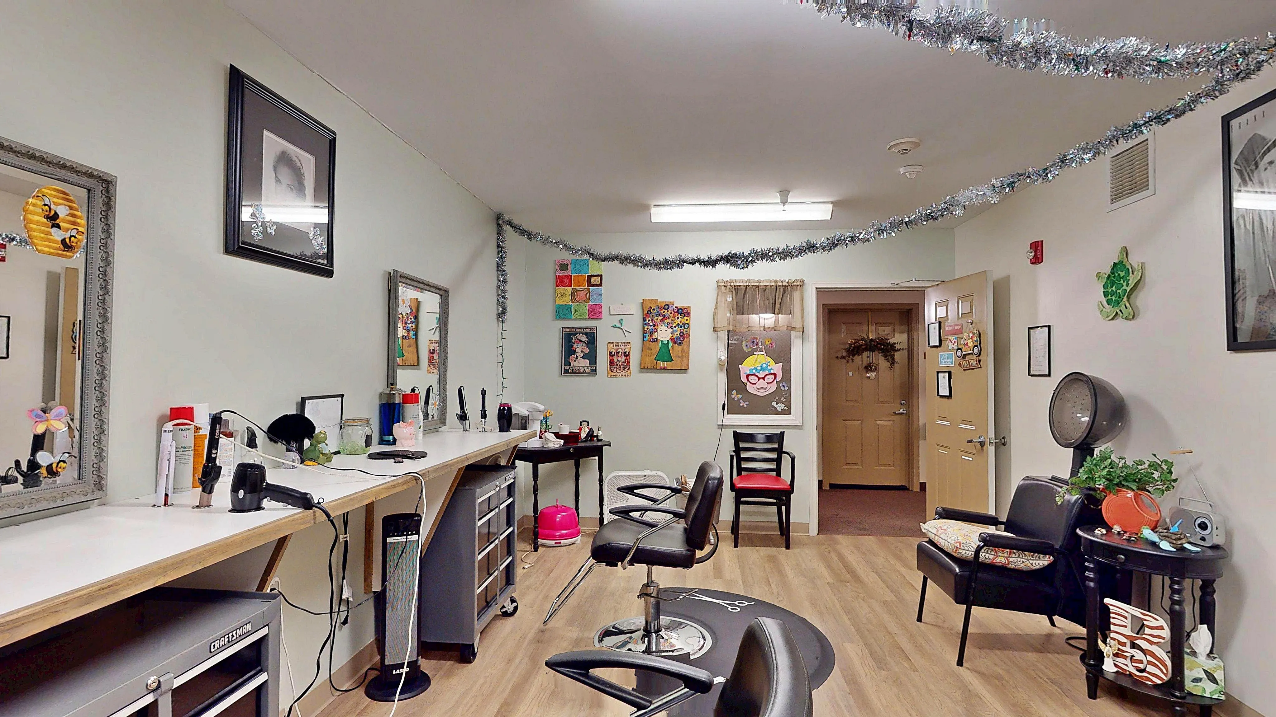Charming hair salon space featuring sleek styling stations, elegant mirrors, and colorful wall art for a welcoming atmosphere.