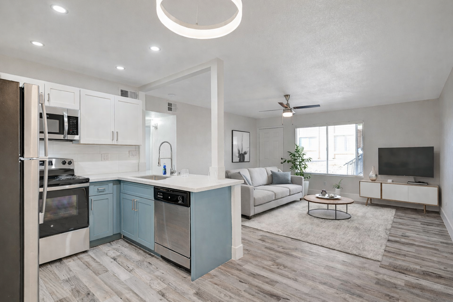 Modern open-concept living space with sleek kitchen, cozy living room, and stylish decor, complemented by natural light and contemporary finishes.