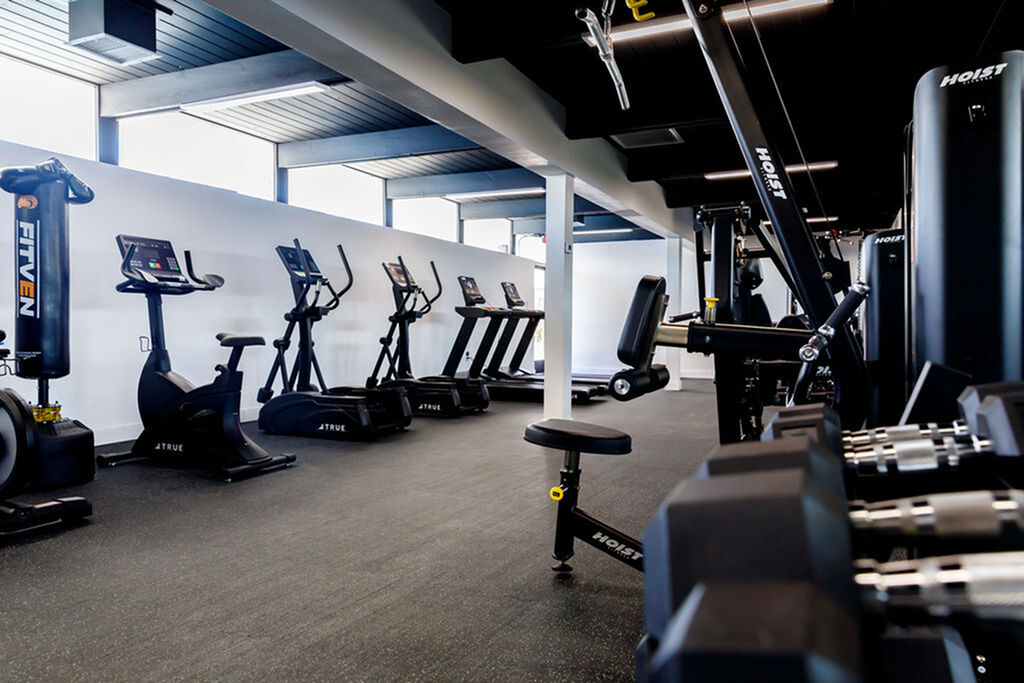 Modern fitness center equipped with state-of-the-art cardio machines and strength training equipment, offering a sleek and motivating exercise environment.