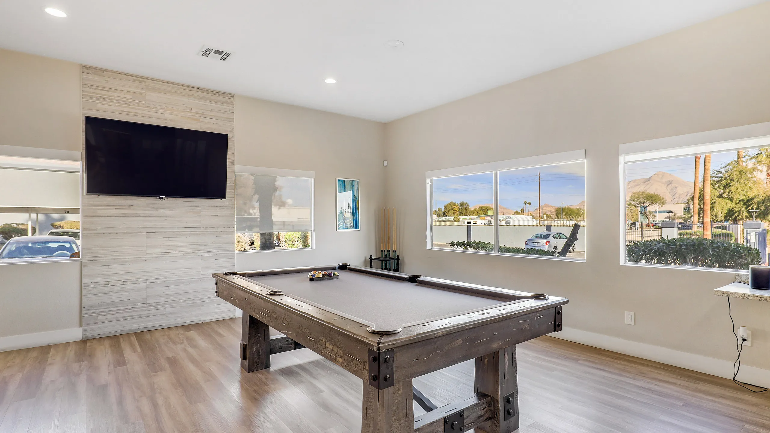 Spacious recreational room featuring a billiards table and large windows offering scenic views.
