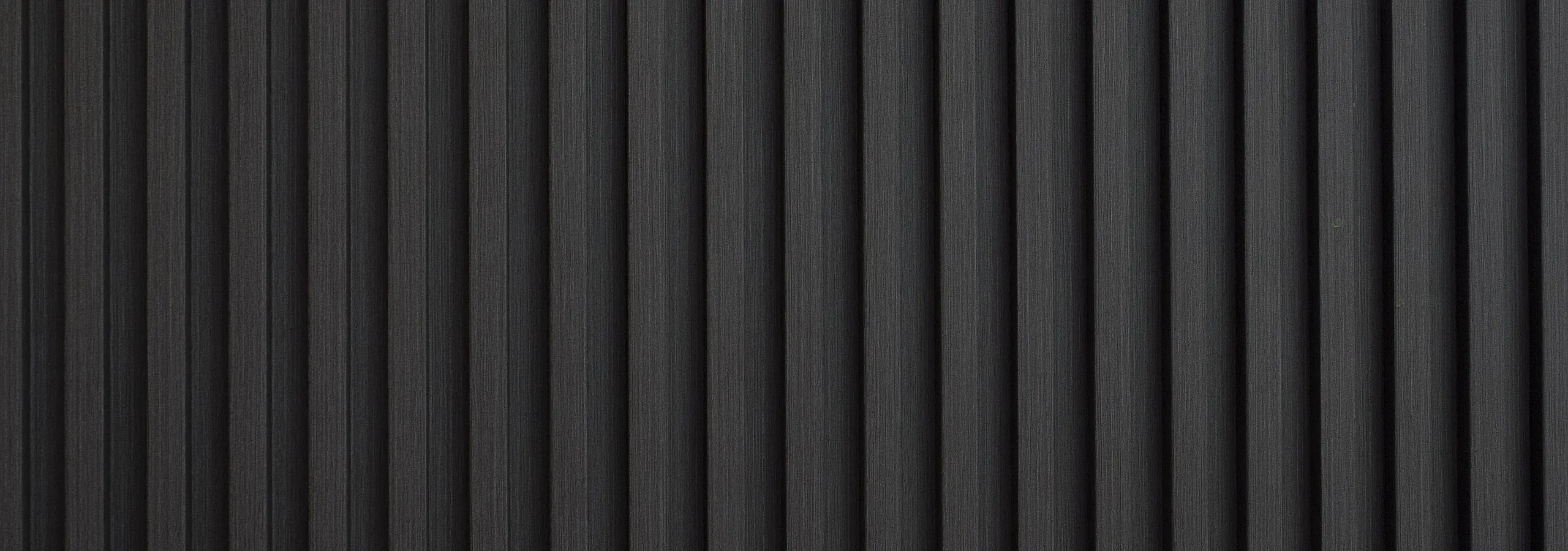Elegant dark gray vertical panels creating a modern, textured accent wall.