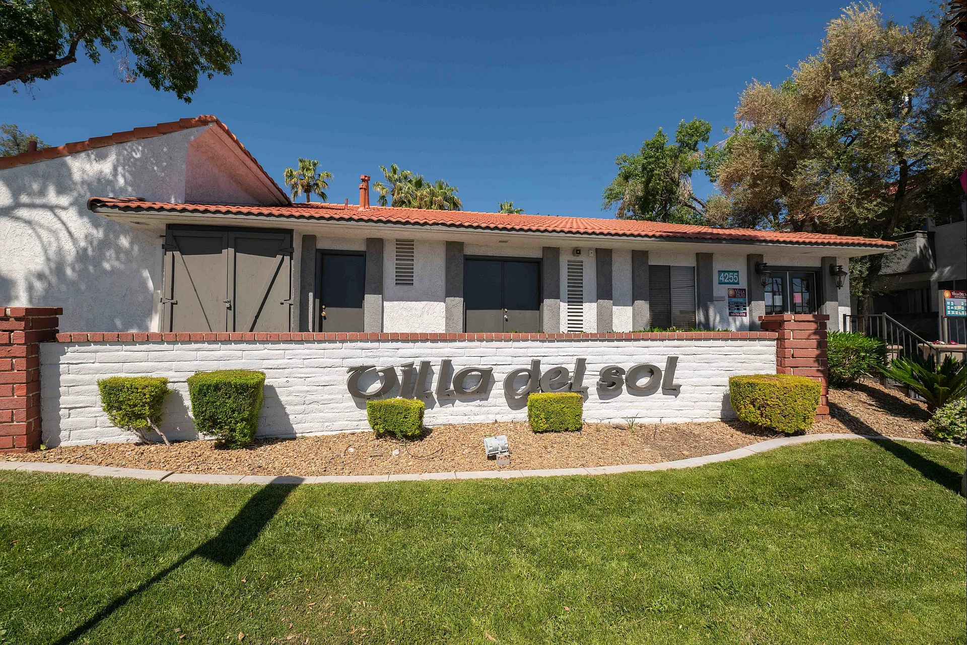 Charming villa with stylish architecture and lush landscaping at Villa del Sol, perfect for modern living.