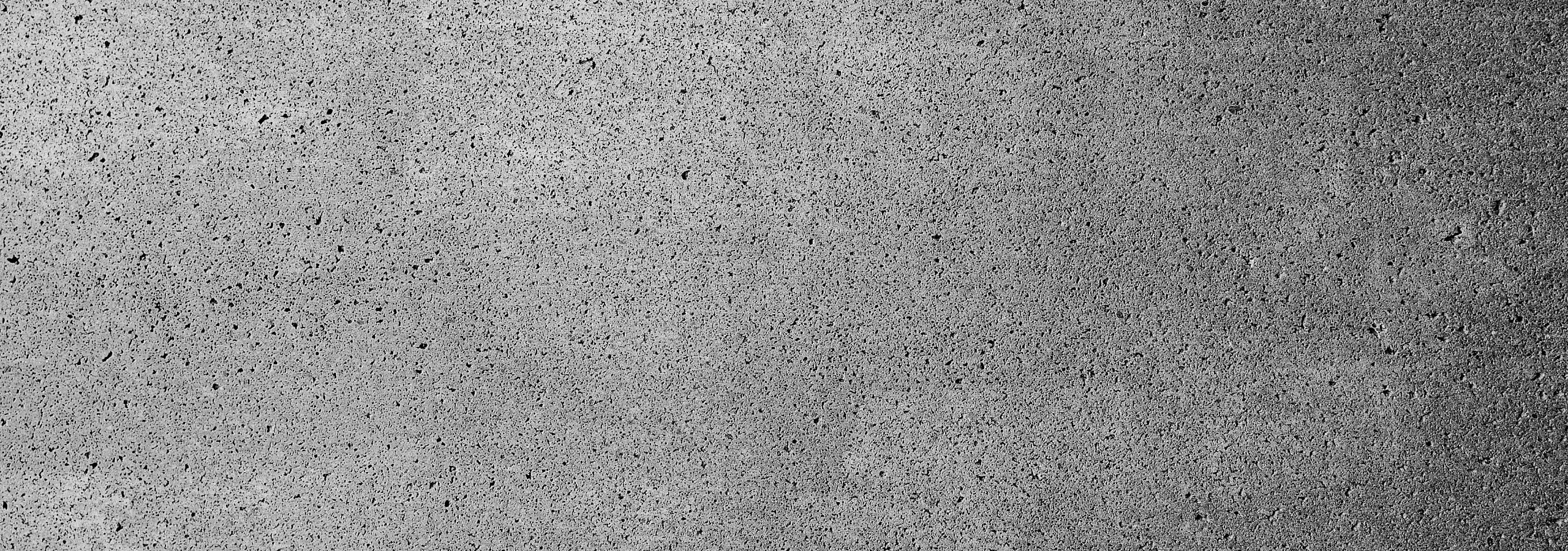 Textured concrete wall with a modern industrial aesthetic, perfect for urban apartment designs.
