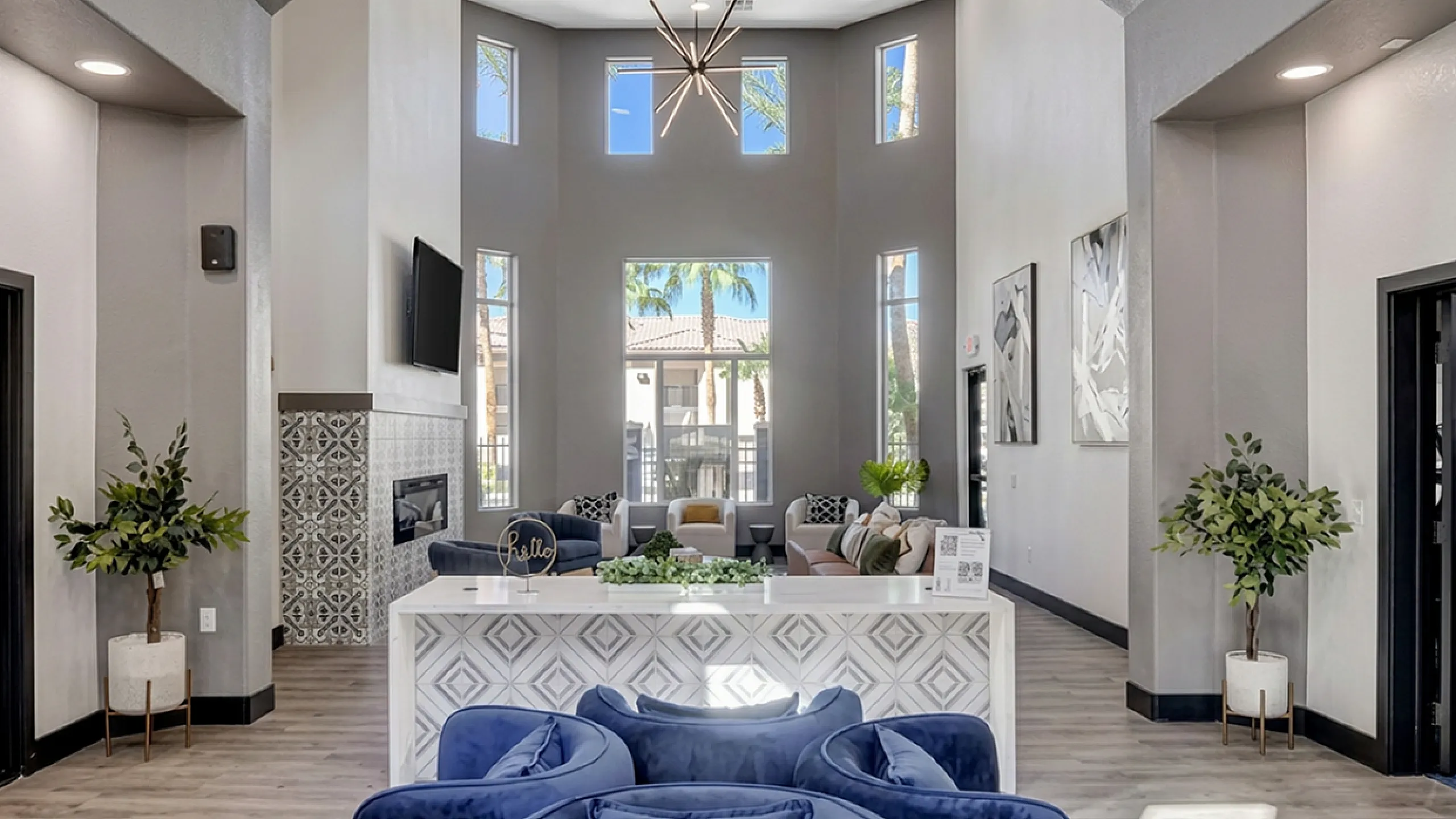 Luxurious lobby with high ceilings, elegant decor, plush seating, and abundant natural light, offering a welcoming and sophisticated atmosphere.