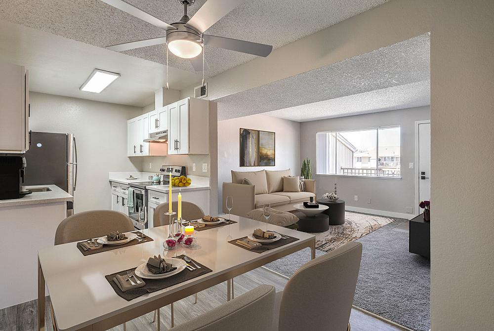 Contemporary open-plan apartment showcasing a stylish kitchen, elegant dining area, and cozy living room with modern decor.