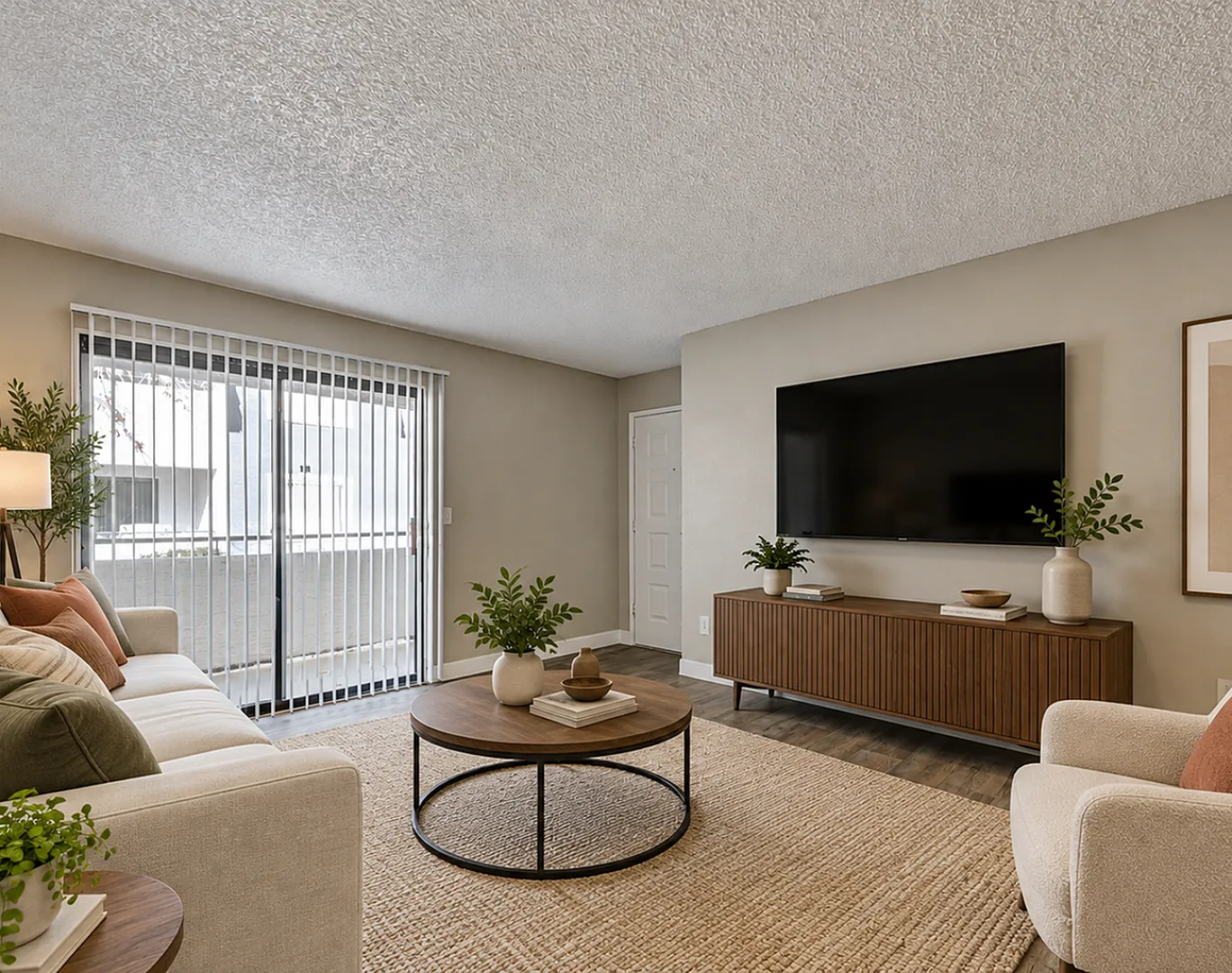 Inviting living room with modern decor, plush seating, and natural light from a large sliding glass door.