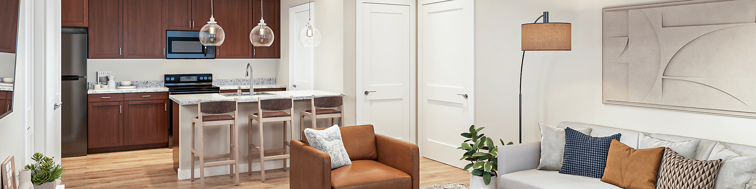 Modern open-concept living room with plush seating, elegant lighting, and a fully-equipped kitchen featuring sleek countertops and wooden cabinetry.