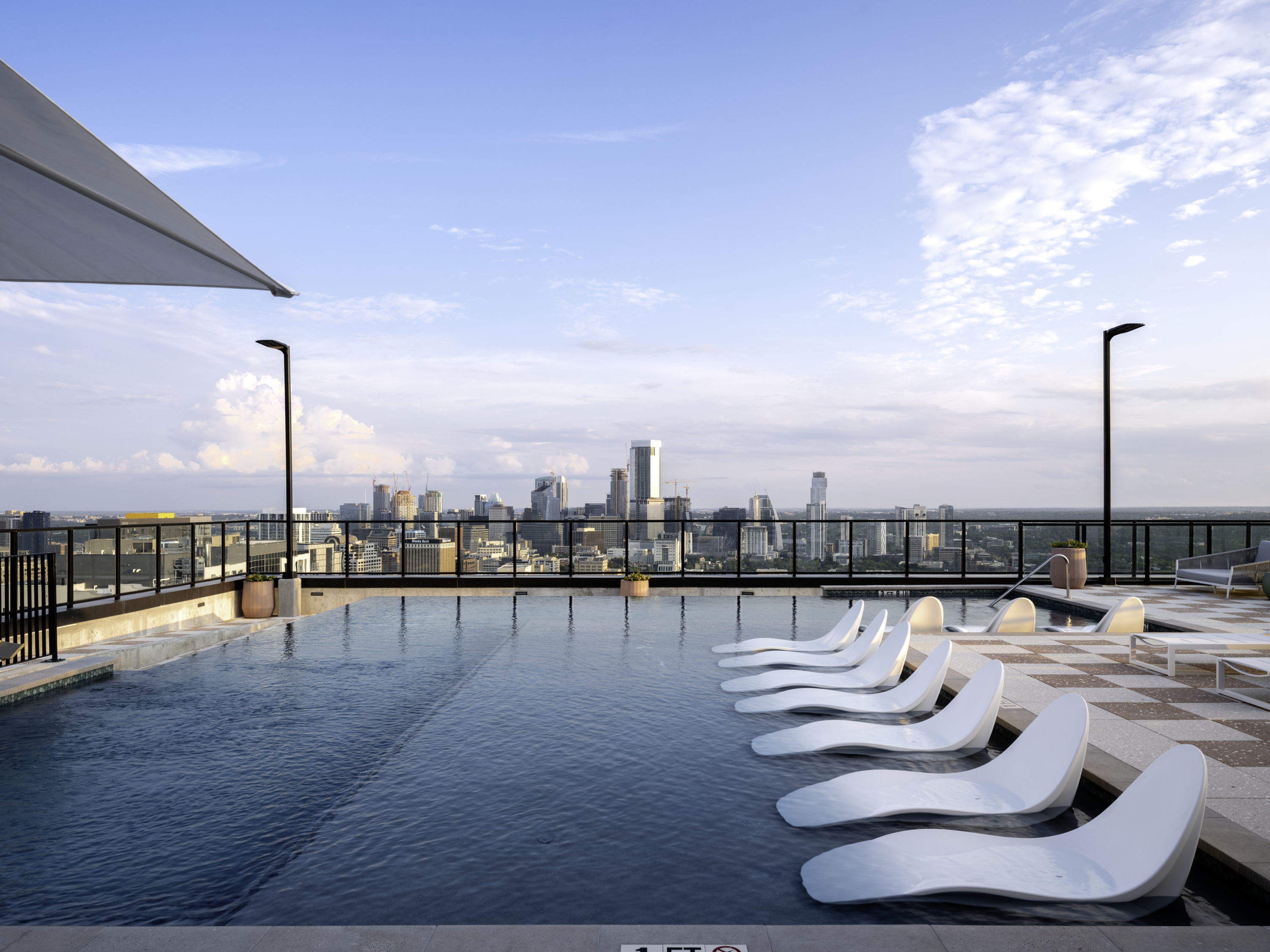 Rooftop pool deck with sun loungers in the pool shelf