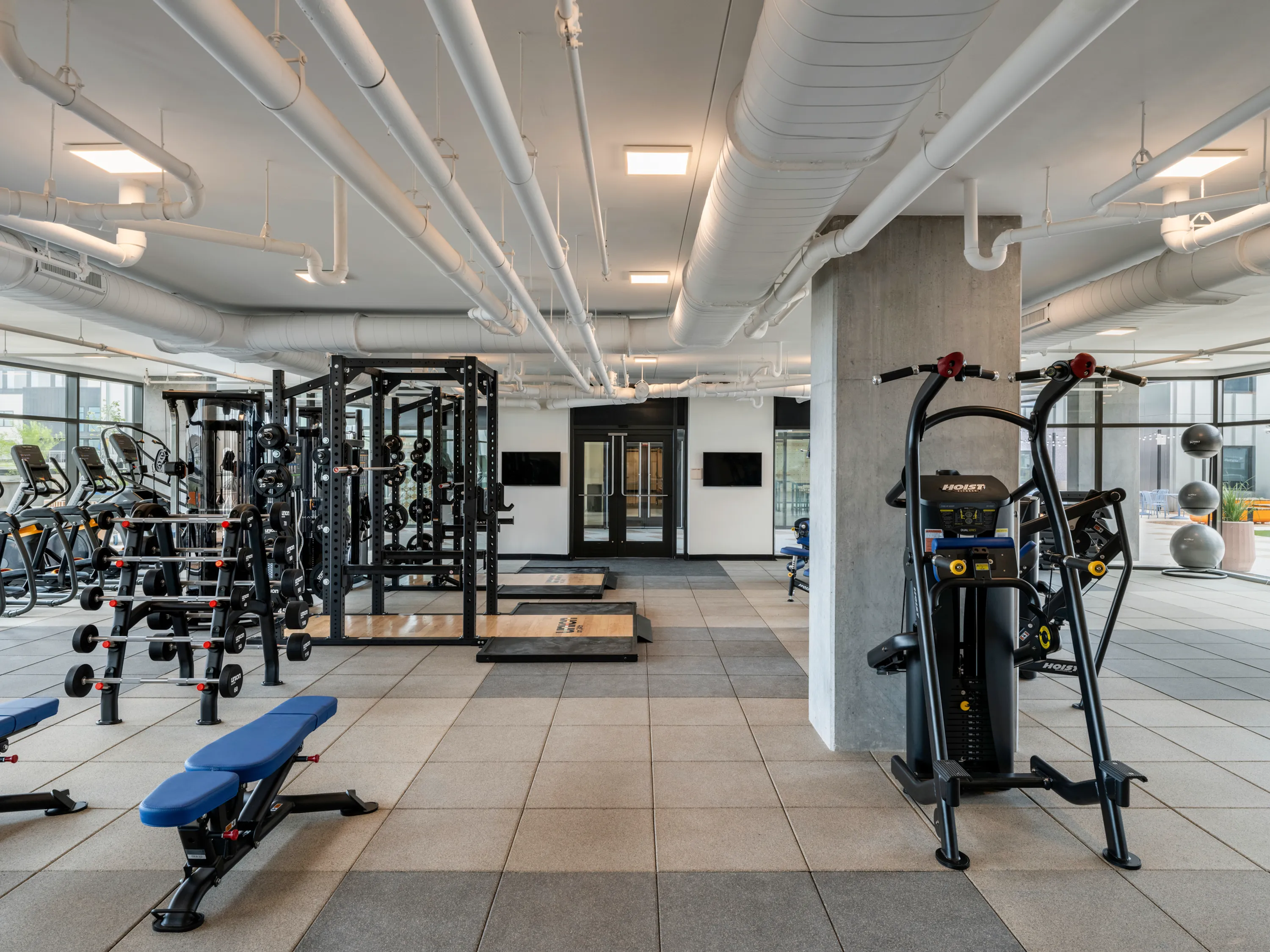 Fitness center with free weights, heavy lifting machines, and space for stretching
