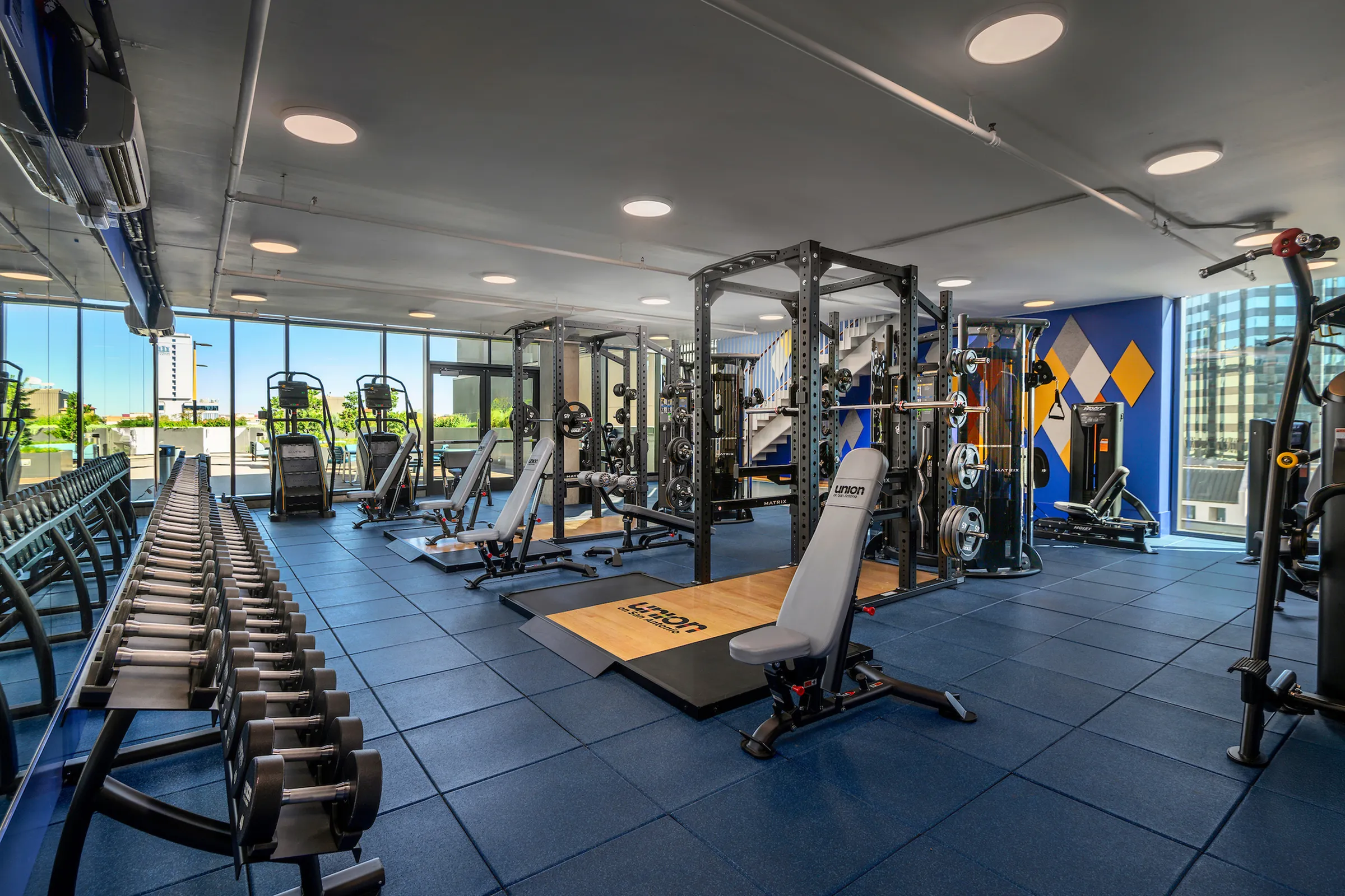 Fitness center with free weights, benches, and heavy lifting machines
