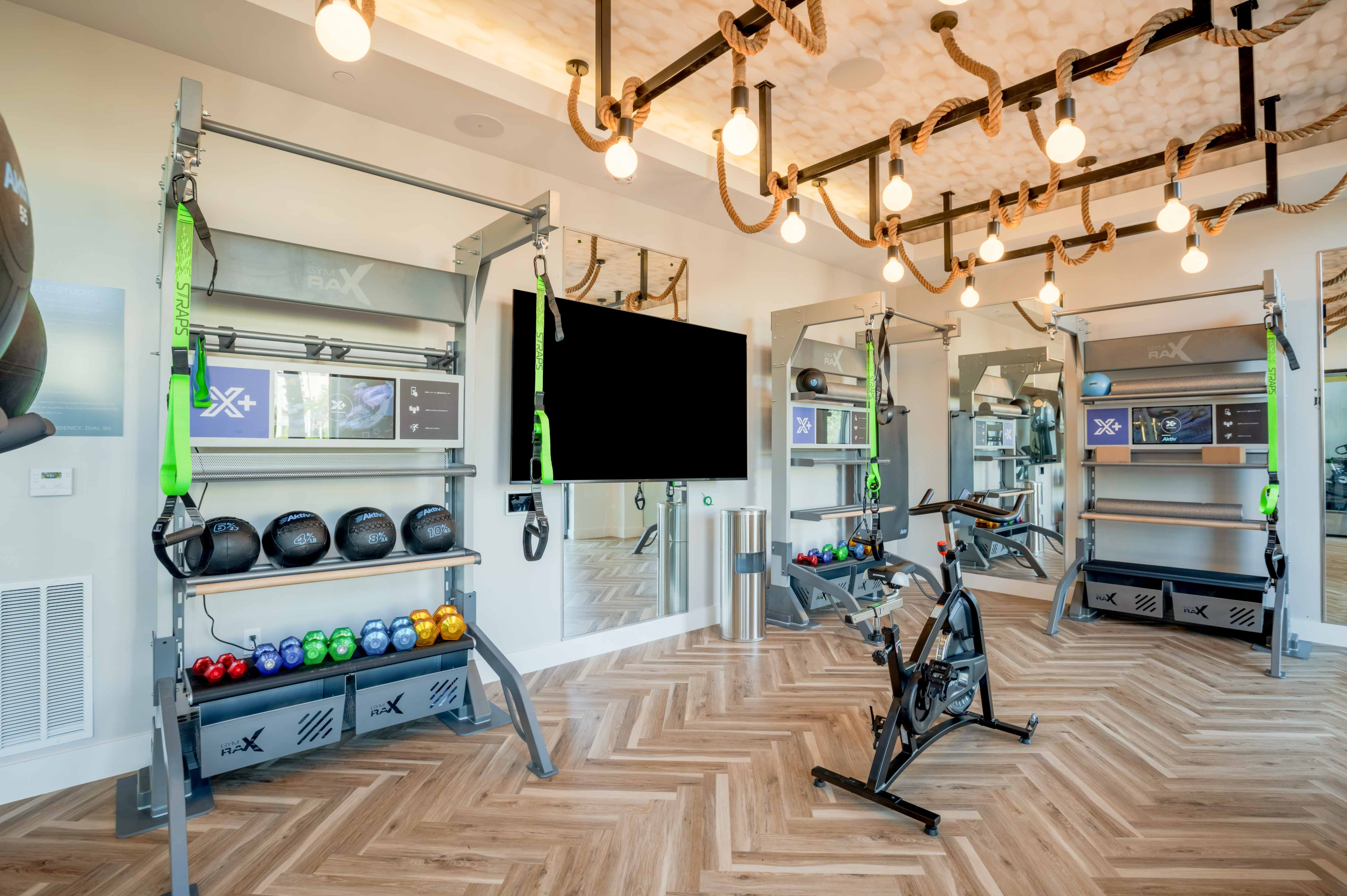 Fitness center with free weights, medicine balls, and a cycling bike