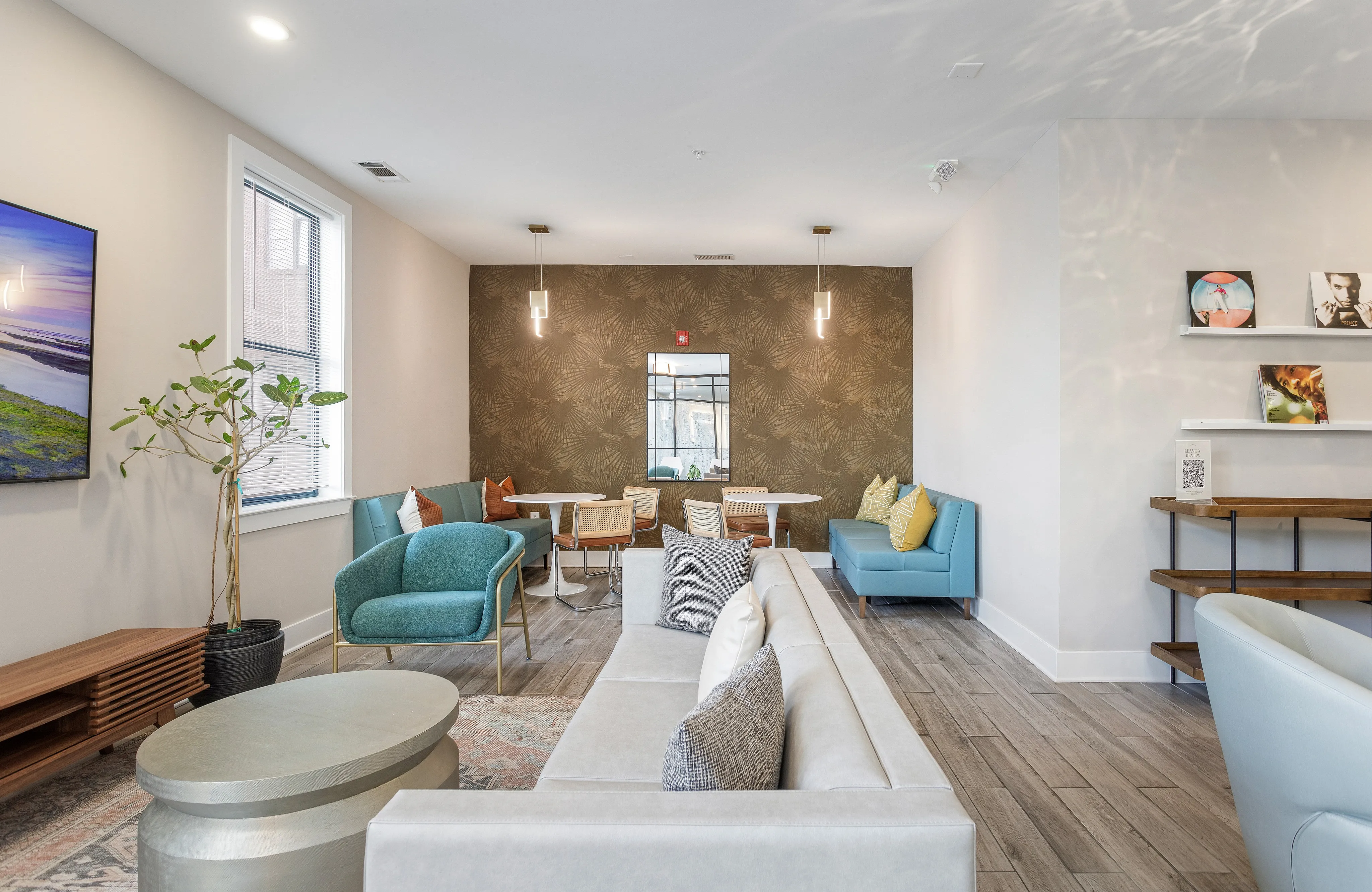 Modern living room with elegant decor, featuring cozy seating, stylish lighting, and contemporary art for a welcoming ambiance.