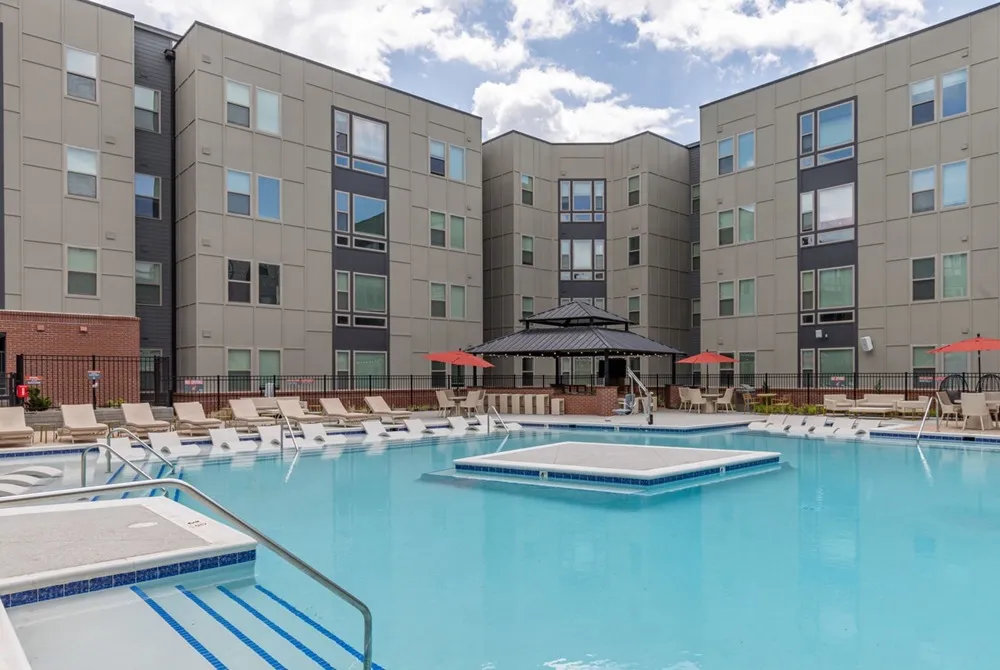Outdoor lounge at Union Blacksburg apartments for rent near Virginia Tech, featuring beach chairs and umbrellas.