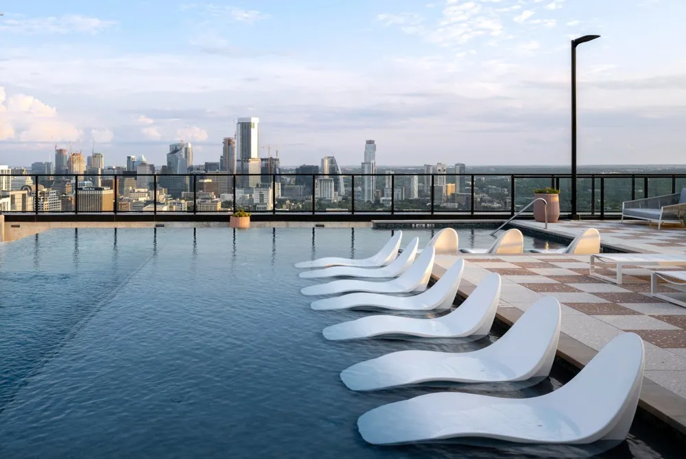 Rooftop pool deck with sun loungers in the pool shelf