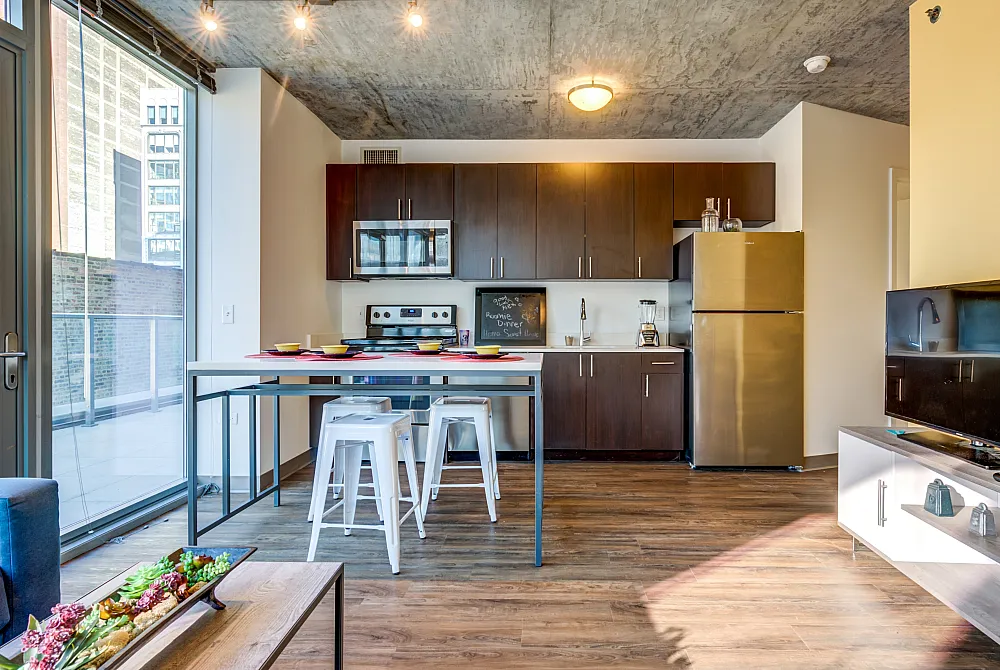 Model apartment kitchen with a dining table and chairs