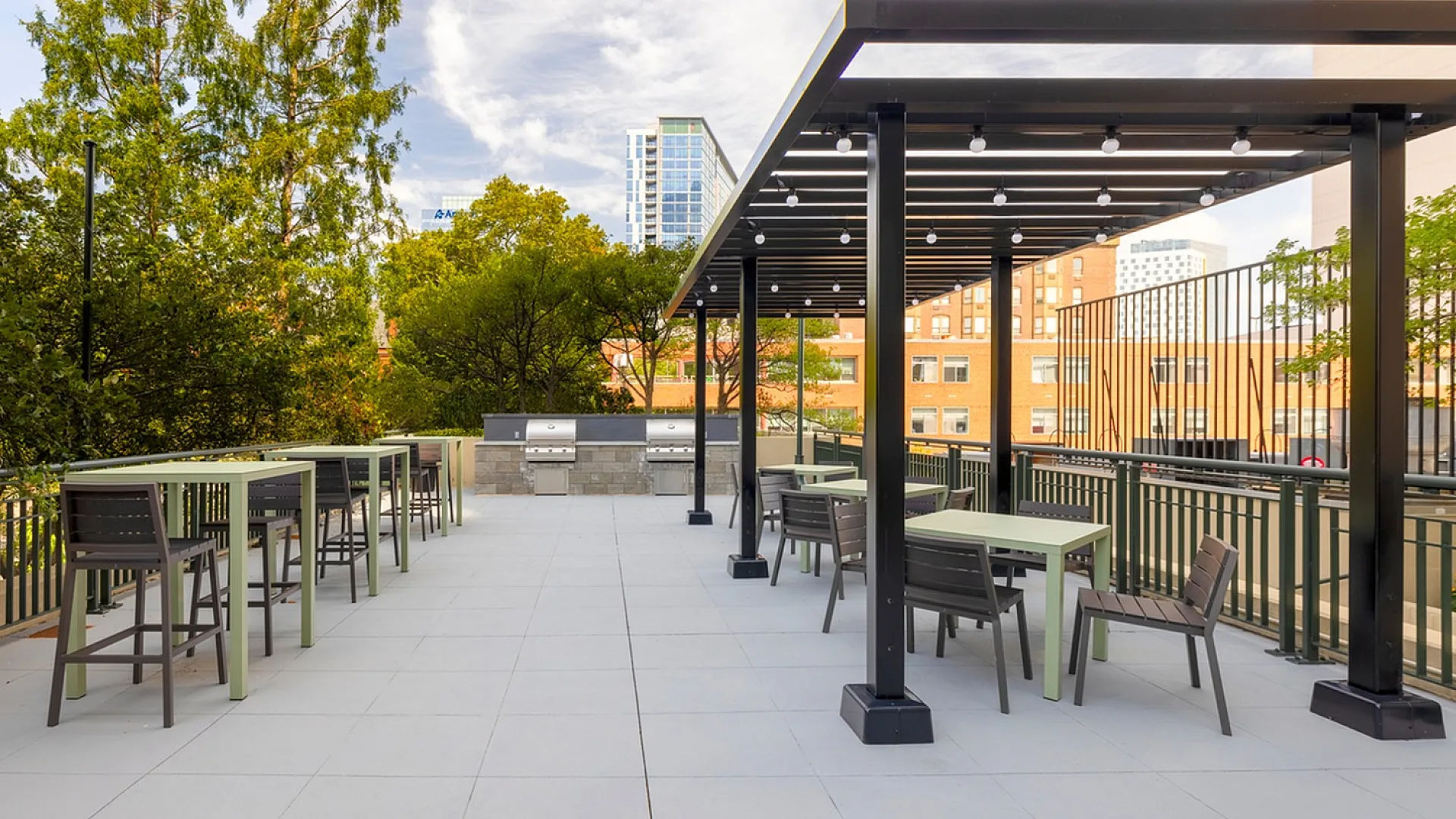 Outdoor lounge at The Accolade on Chestnut apartments in Philadelphia, PA, featuring a shade structure and grill stations.