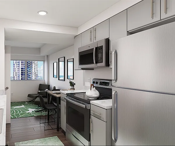 Model kitchen and living room at The Accolade on Chestnut apartments in Philadelphia, PA featuring wood grain floor paneling.