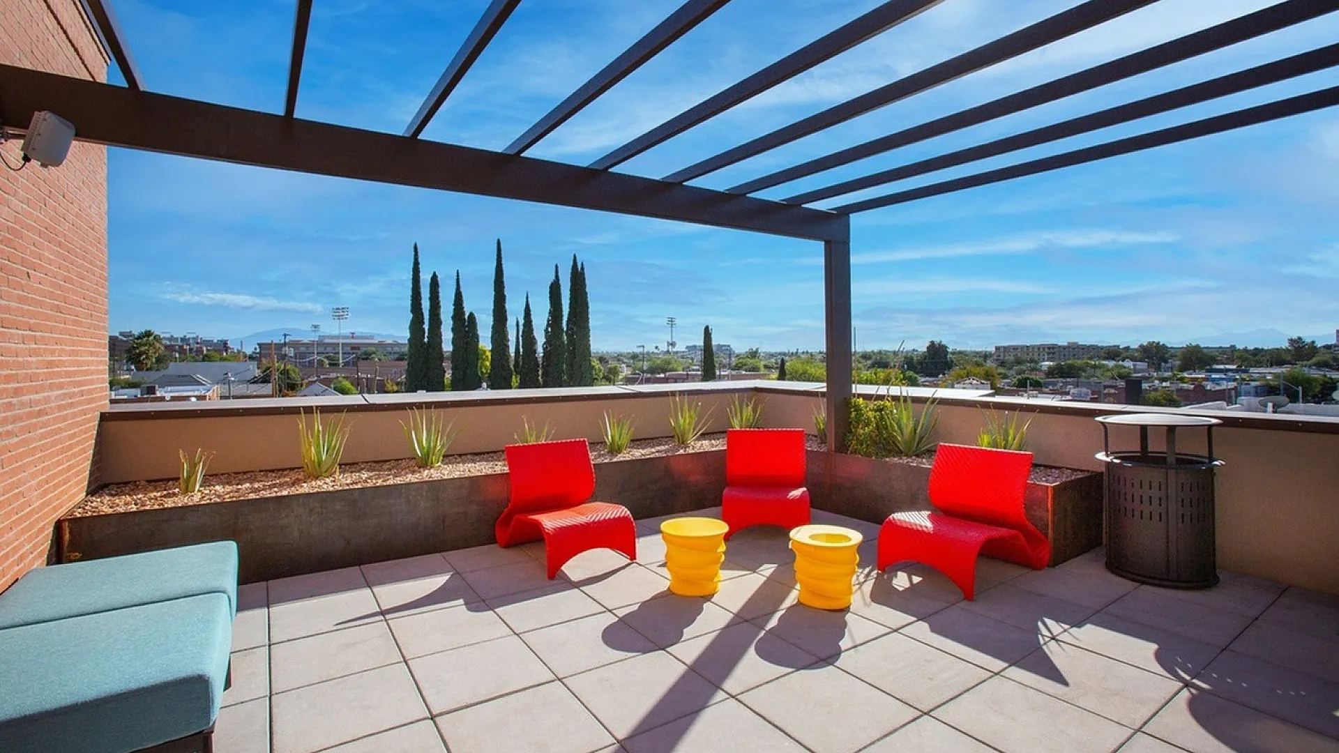 Model apartment living room with brightly colored decor and furniture all directed at the flat screen tv