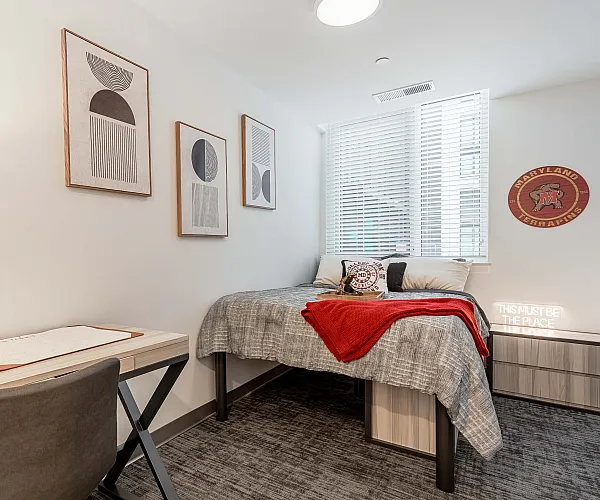Model apartment bedroom with a full size bed and dressers