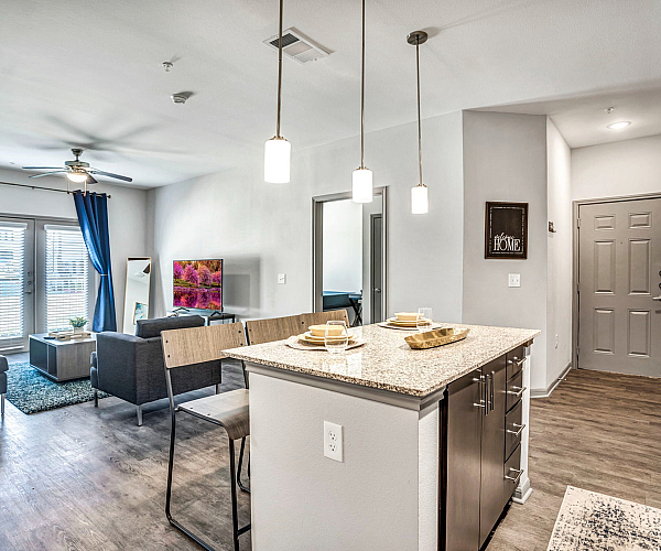 Inviting modern living space with open-concept design featuring a stylish kitchen island, cozy living area, and elegant decor.