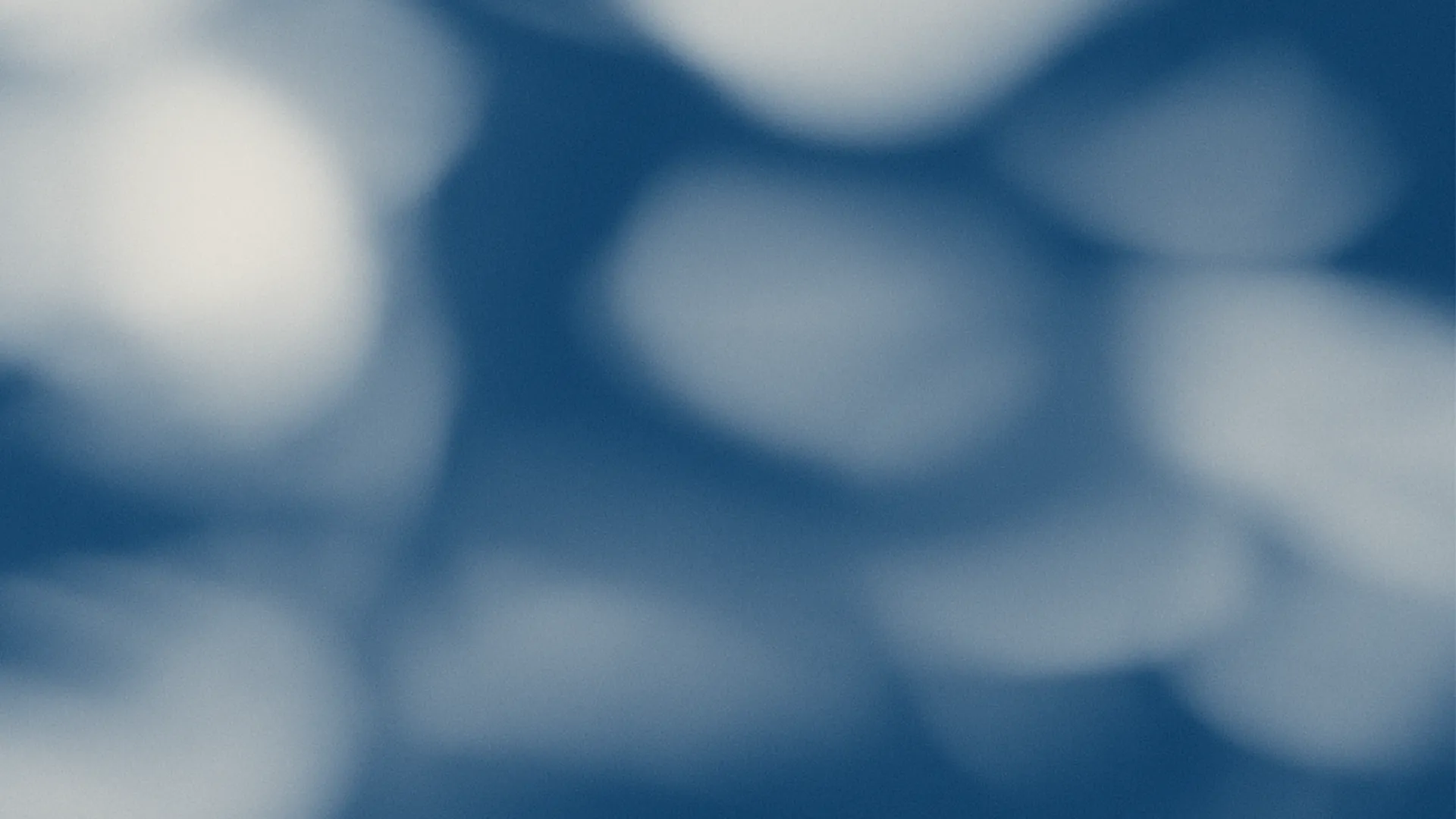 Abstract image with soft blue and white bokeh effect creating a calming and dreamy atmosphere.