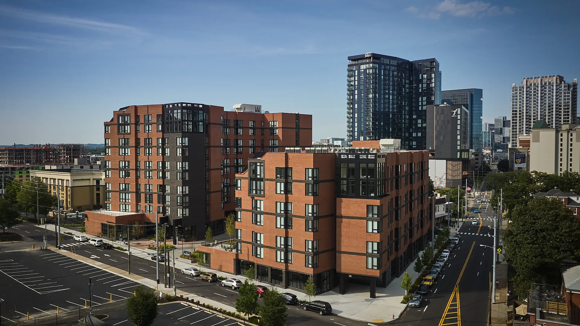 Impressive urban apartment complex featuring modern brick architecture surrounded by vibrant cityscape, ideal for city living.