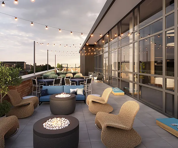 Chic rooftop terrace adorned with cozy wicker chairs, modern fire pits, and vibrant string lights, offering a perfect urban retreat.