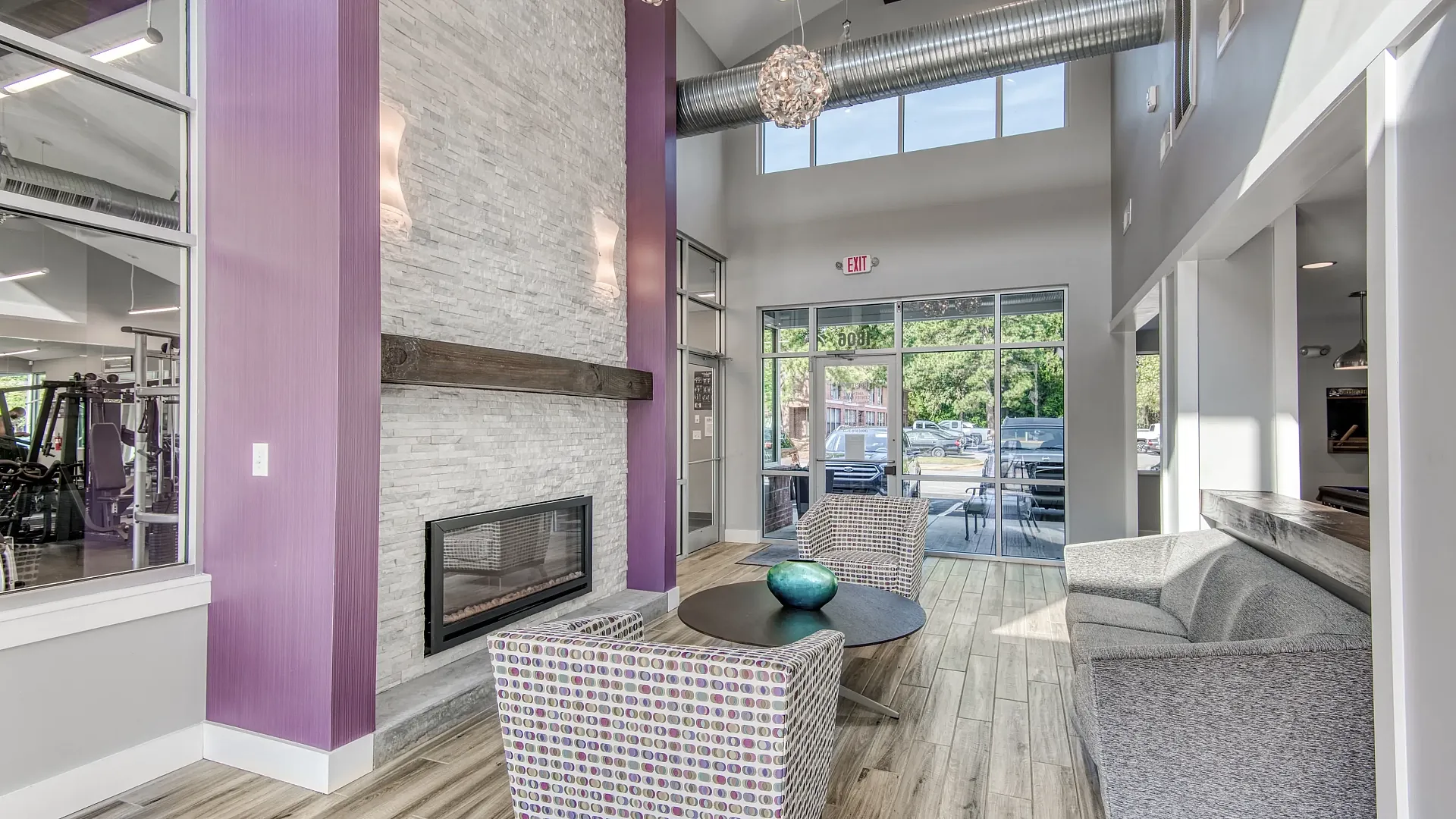 Inviting modern apartment lobby featuring stylish seating, contemporary decor, and a reception desk at The District.