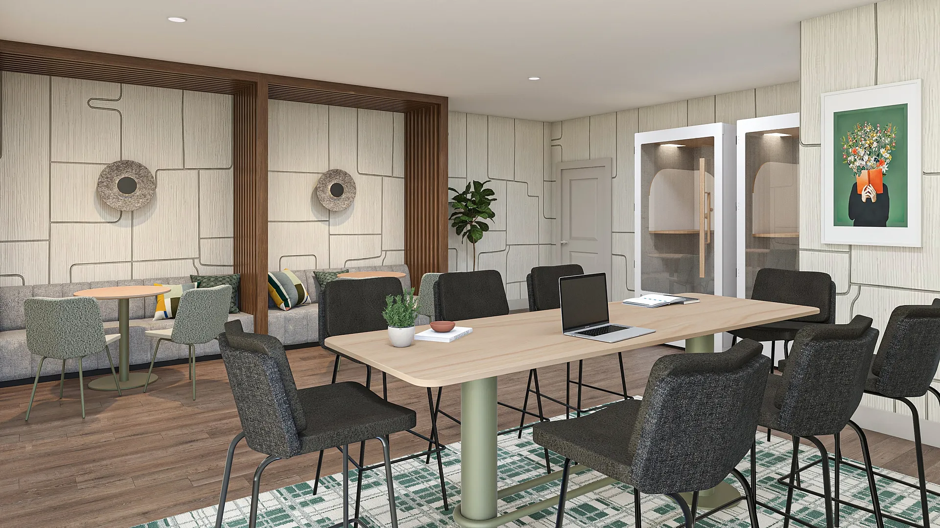 Modern co-working space featuring stylish seating, a large table with a laptop, and vibrant decor.