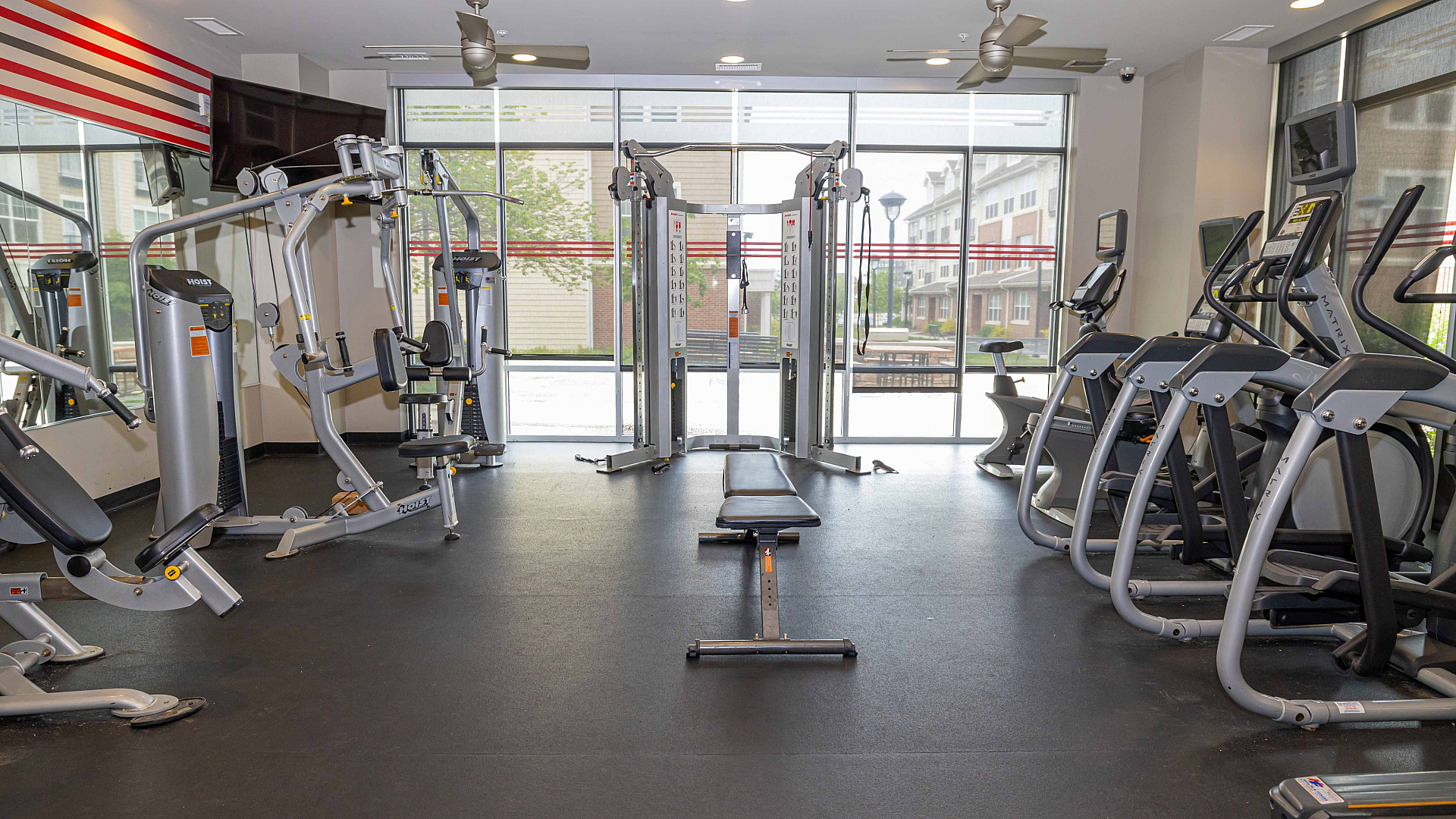 Modern fitness center featuring state-of-the-art exercise equipment and bright natural lighting.