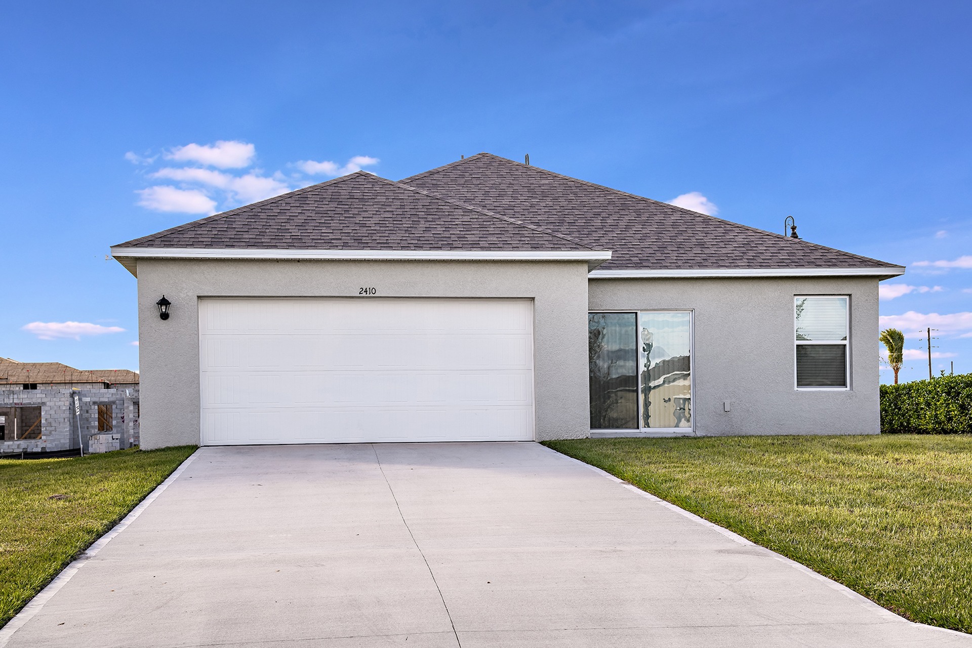 Exterior view with attached garage at a home for rent in Apopka, Florida.