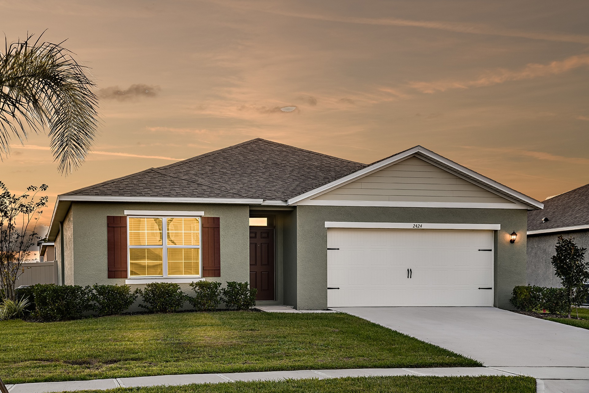 Exterior view of home with attached garage during a beautiful sunset for rent in Apopka, Florida.
