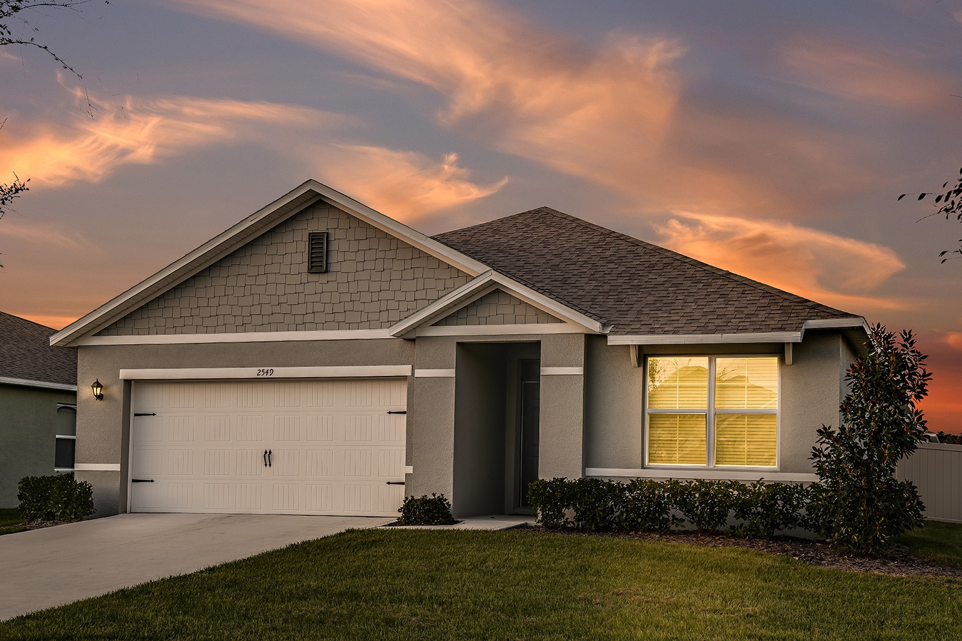 Photograph of the exterior of one of our 1 story townhomes in Apopka, FL, featuring a driveway and garage.