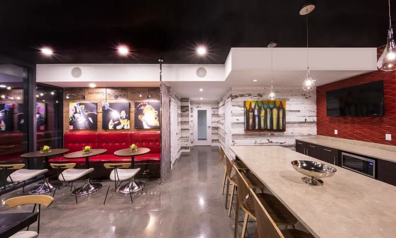 Common lounge and dining area at our apartments in Atlanta, GA, featuring ample seating, colorful decor, and hanging lights.